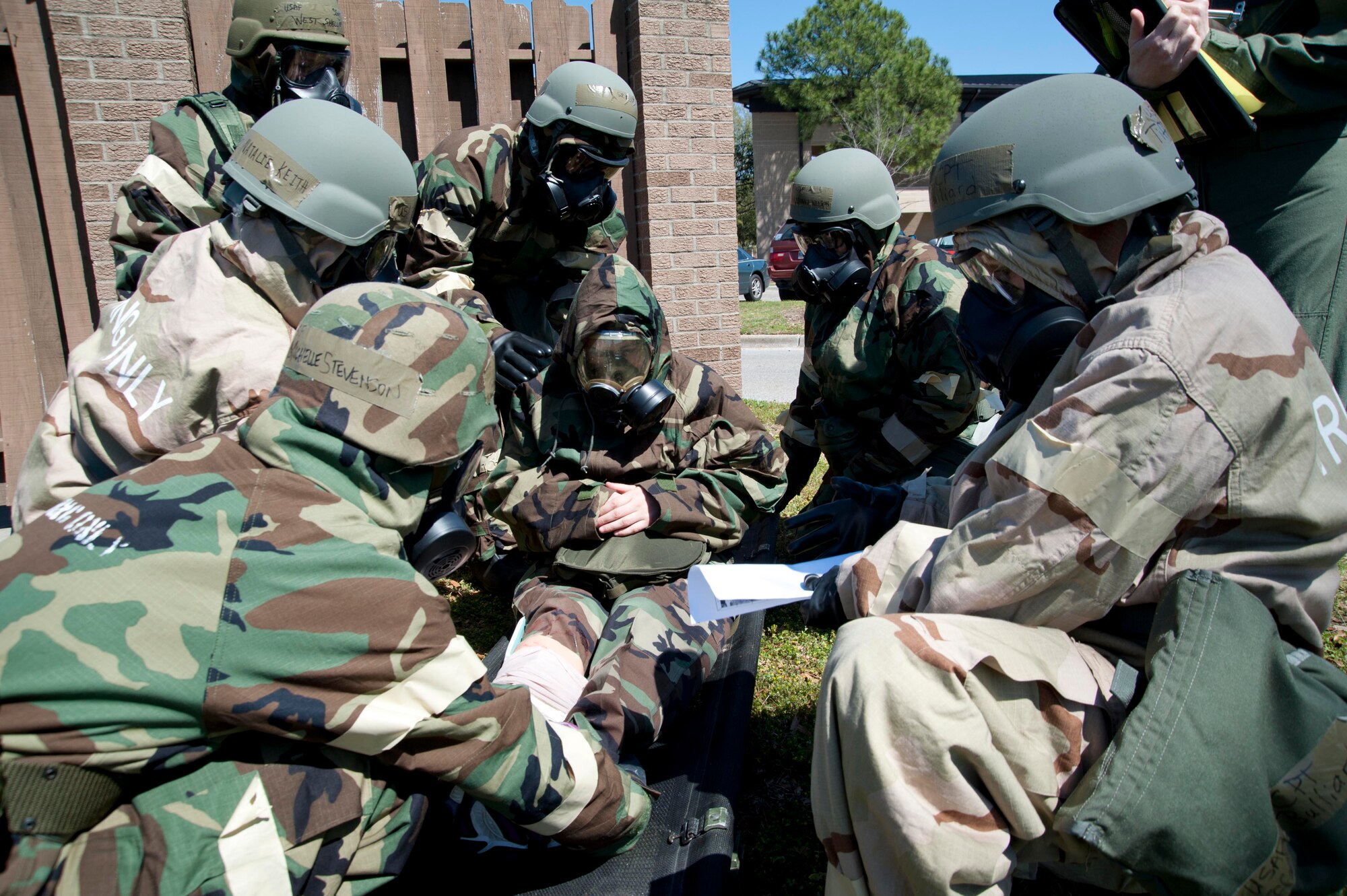 Capt. Jeffrey Hicks; 815th Airlift Squadron pilot; and Tech. Sgt. Shari Belcher; 403rd Aeromedical Staging Squadron medical technician; secure a gas mask to an Airman who fell victim to a simulated chemical attack. As member of the Post-Attack Reconnaissance Team; the captain and sergeant swept the area around the 815th AS building for signs of damage; chemical agents; unexploded ordnance; and casualties. This is part of their training for the 403rd Wing’s upcoming Operational Readiness Inspection. (U.S. Air Force photo by Tech. Sgt. Ryan Labadens)