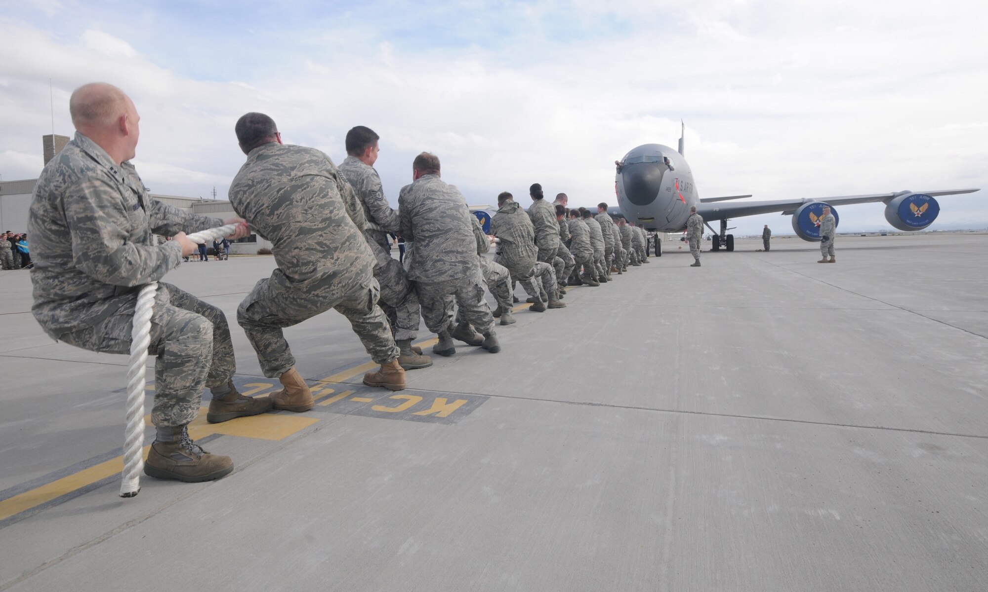 Members of the 151st Air Refueling Wing pull a KC-135 Stratotanker in a" Plane-Pull" competition as part of Winter Wingman Day, March 12, 2011, at the Utah Air National Guard base in Salt Lake City. Teams competed to see who could pull the 120,00+ pound aircraft over a 40 feet distance in the shortest time. (U.S. Air Force photo by Master Sgt. Gary J. Rihn)(RELEASED)