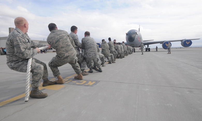 Members of the 151st Air Refueling Wing pull a KC-135 Stratotanker in a" Plane-Pull" competition as part of Winter Wingman Day, March 12, 2011, at the Utah Air National Guard base in Salt Lake City. Teams competed to see who could pull the 120,00+ pound aircraft over a 40 feet distance in the shortest time. (U.S. Air Force photo by Master Sgt. Gary J. Rihn)(RELEASED)