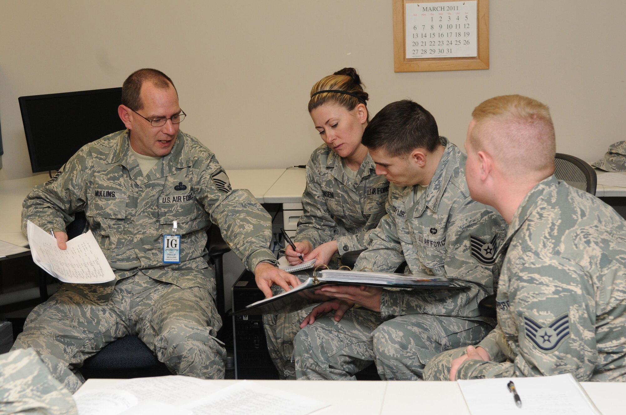 Master Sgt. Phillip Mullins of the Inspector General team takes time to explain a question on the checklist to Master Sgt. Lisa Jensen, Tech. Sgt. Leo Taylor, and Staff Sgt. Bryan of the 151st Communications Flight during their Compliance Inspection on Feb. 26, 2011, at the Utah Air National Guard Base in Salt Lake City. (U.S. Air Force photo by Master Sergeant Gary J. Rihn)(RELEASED)