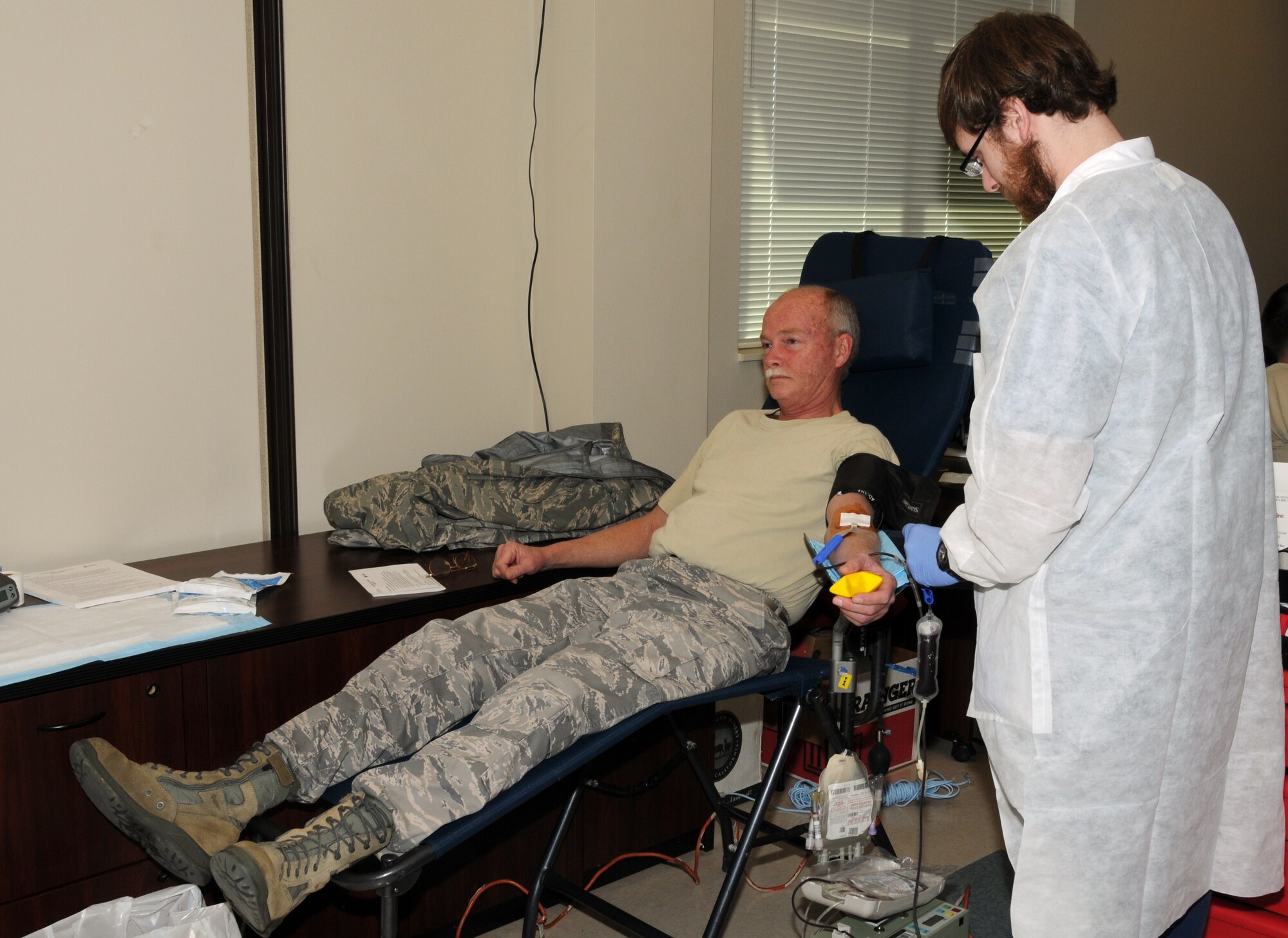 Colonel Randall D. Myers, Commander of the 164th Maintenance Group, rolls up his sleeves and donates bllod during the base's semi-annual blood drive.