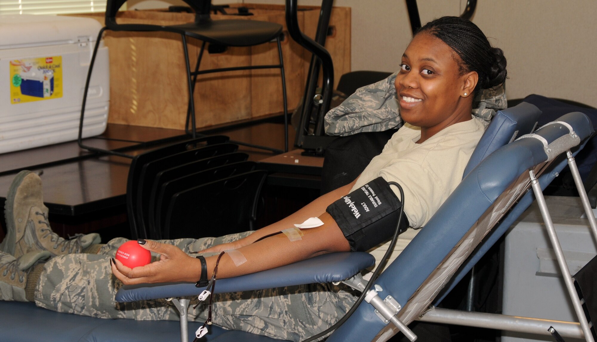 Technical Sergeant Sherveta Wright, Knowledge Operations Manager for the 164th Airlift Wing, puts on a brave smile as she donates blood during the base's semi-annual blood drive.