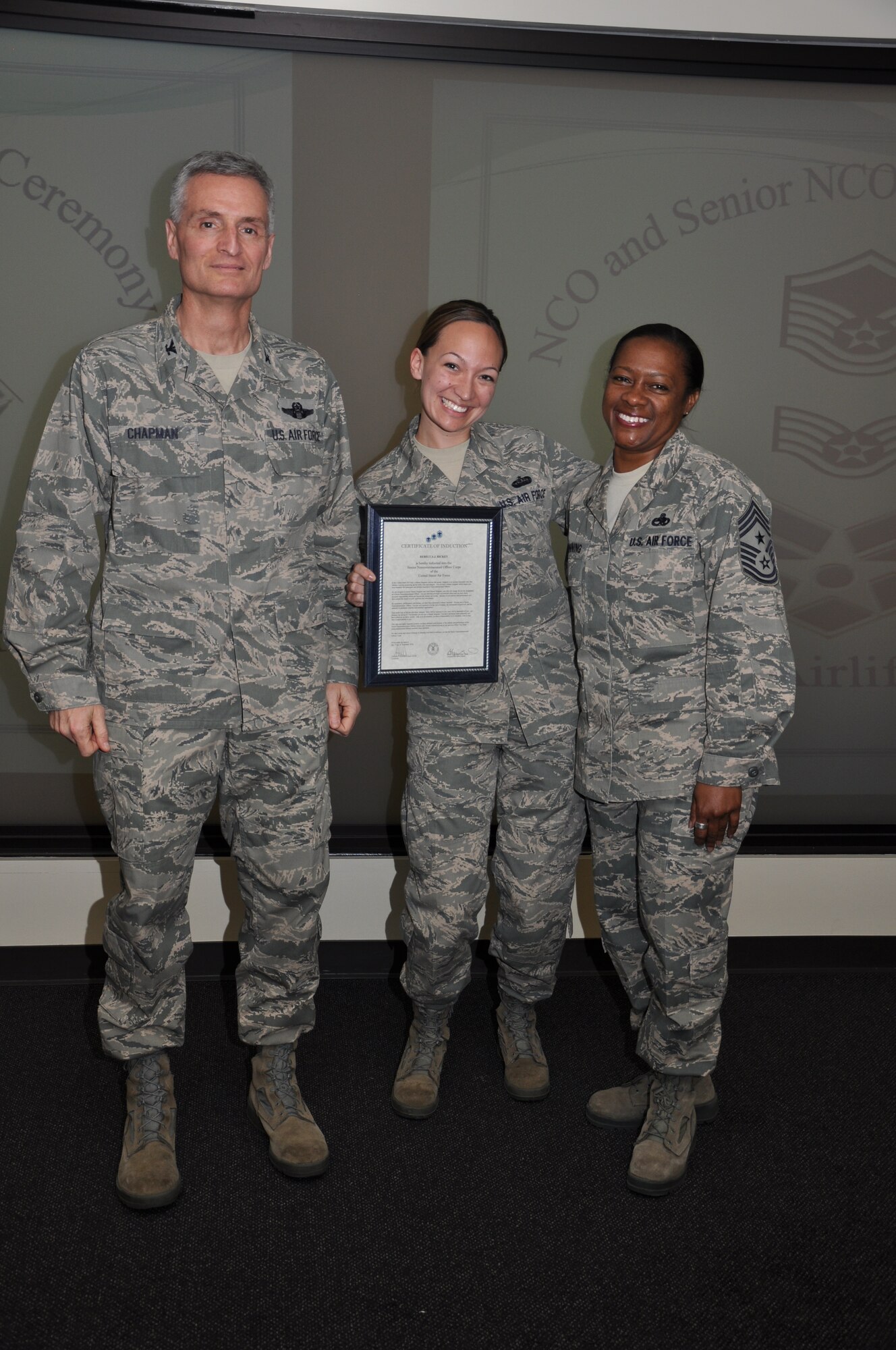Col Steven Chapman and Command Chief Master Sergeant Gigi Manning congratulated the 315th Airlift Wing's newest NCOs and Senior NCOs during a ceremony here March 12. The induction ceremony recognized 18 airmen as they reached a personal and professional milestone.(U.S. AirForce photo/SSgt Shane Ellis)