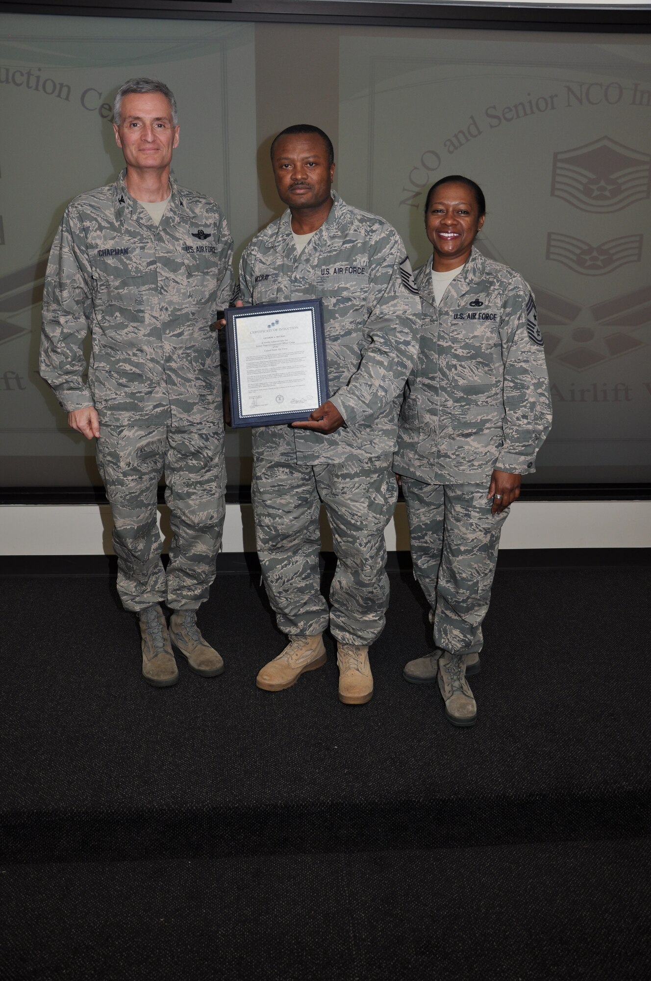 Col Steven Chapman and Command Chief Master Sergeant Gigi Manning congratulated the 315th Airlift Wing's newest NCOs and Senior NCOs during a ceremony here March 12. The induction ceremony recognized 18 airmen as they reached a personal and professional milestone.(U.S. AirForce photo/SSgt Shane Ellis)