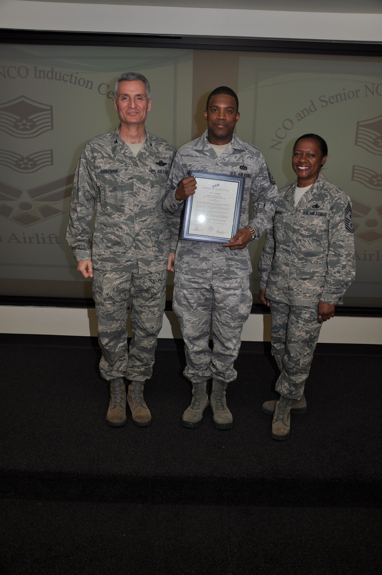 Col Steven Chapman and Command Chief Master Sergeant Gigi Manning congratulated the 315th Airlift Wing's newest NCOs and Senior NCOs during a ceremony here March 12. The induction ceremony recognized 18 airmen as they reached a personal and professional milestone.(U.S. AirForce photo/SSgt Shane Ellis)
