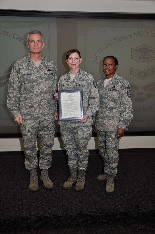 Col Steven Chapman and Command Chief Master Sergeant Gigi Manning congratulated the 315th Airlift Wing's newest NCOs and Senior NCOs during a ceremony here March 12. The induction ceremony recognized 18 airmen as they reached a personal and professional milestone.(U.S. AirForce photo/SSgt Shane Ellis)