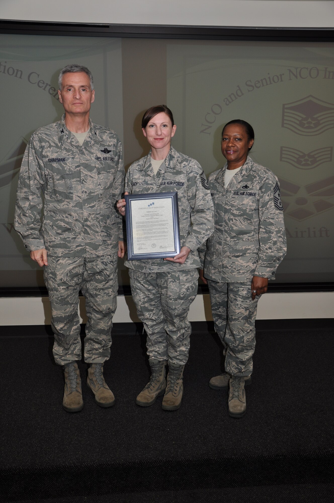 Col Steven Chapman and Command Chief Master Sergeant Gigi Manning congratulated the 315th Airlift Wing's newest NCOs and Senior NCOs during a ceremony here March 12. The induction ceremony recognized 18 airmen as they reached a personal and professional milestone.(U.S. AirForce photo/SSgt Shane Ellis)