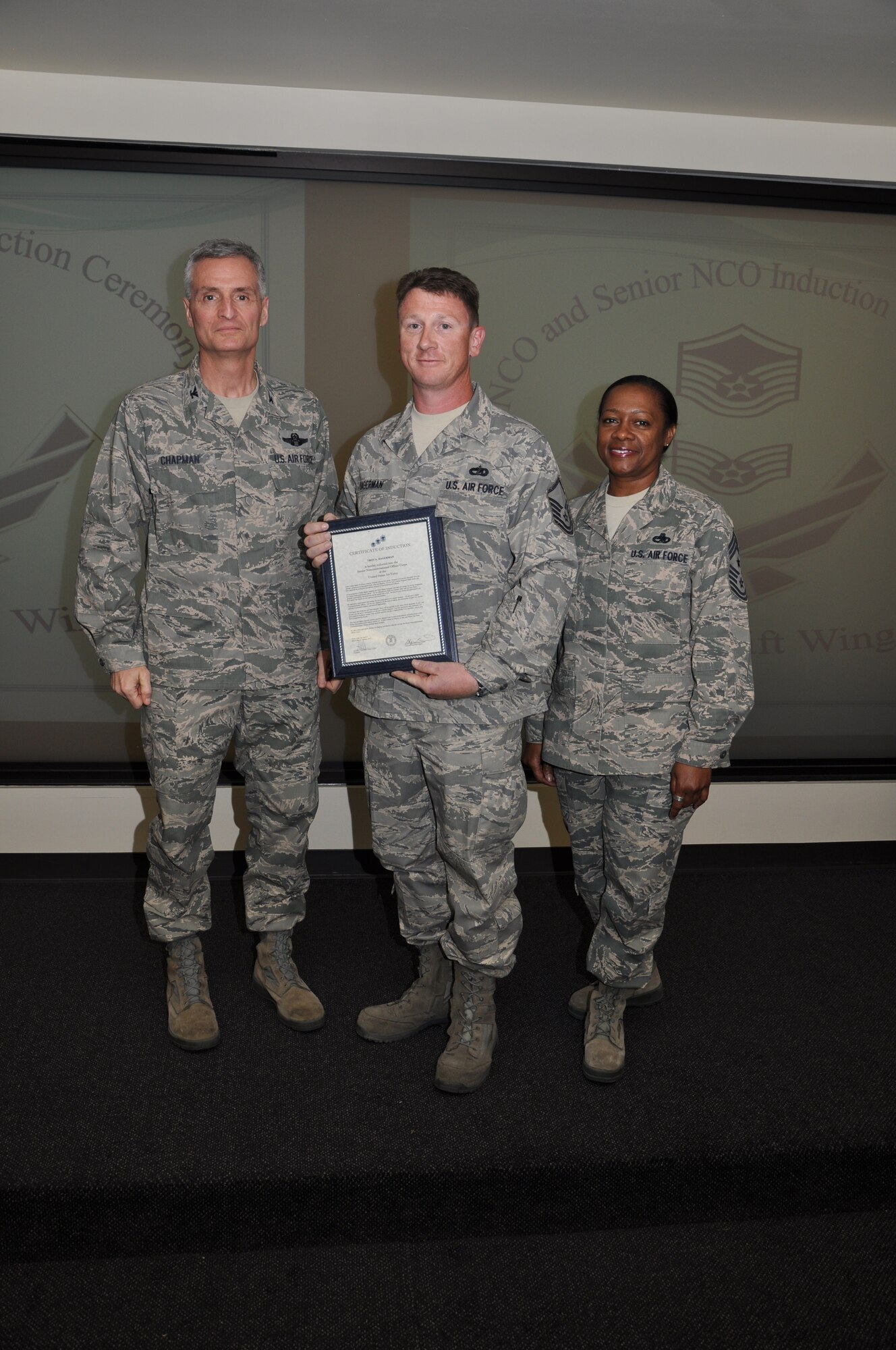 Col Steven Chapman and Command Chief Master Sergeant Gigi Manning congratulated the 315th Airlift Wing's newest NCOs and Senior NCOs during a ceremony here March 12. The induction ceremony recognized 18 airmen as they reached a personal and professional milestone.(U.S. AirForce photo/SSgt Shane Ellis)