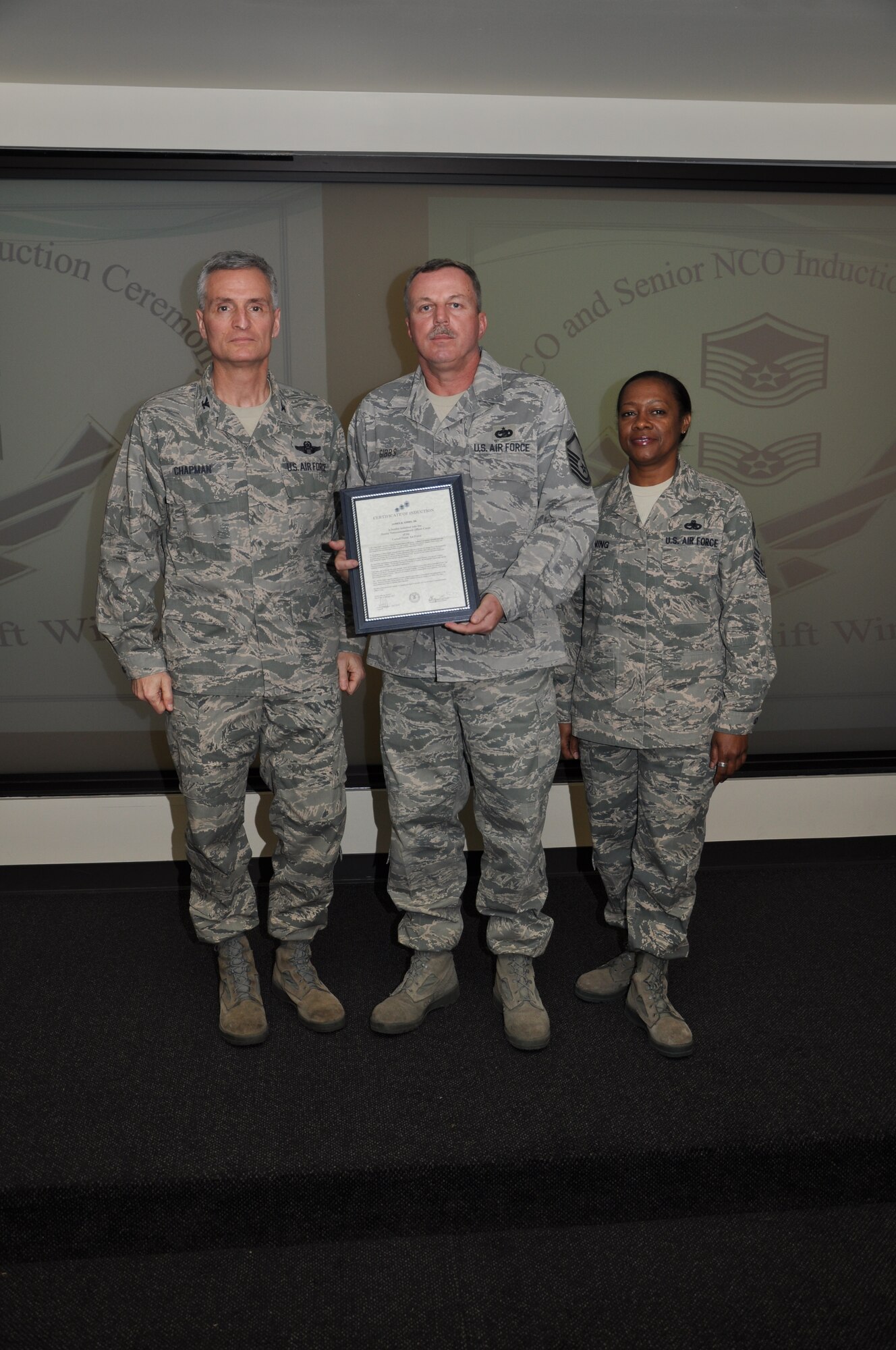 Col Steven Chapman and Command Chief Master Sergeant Gigi Manning congratulated the 315th Airlift Wing's newest NCOs and Senior NCOs during a ceremony here March 12. The induction ceremony recognized 18 airmen as they reached a personal and professional milestone.(U.S. AirForce photo/SSgt Shane Ellis)