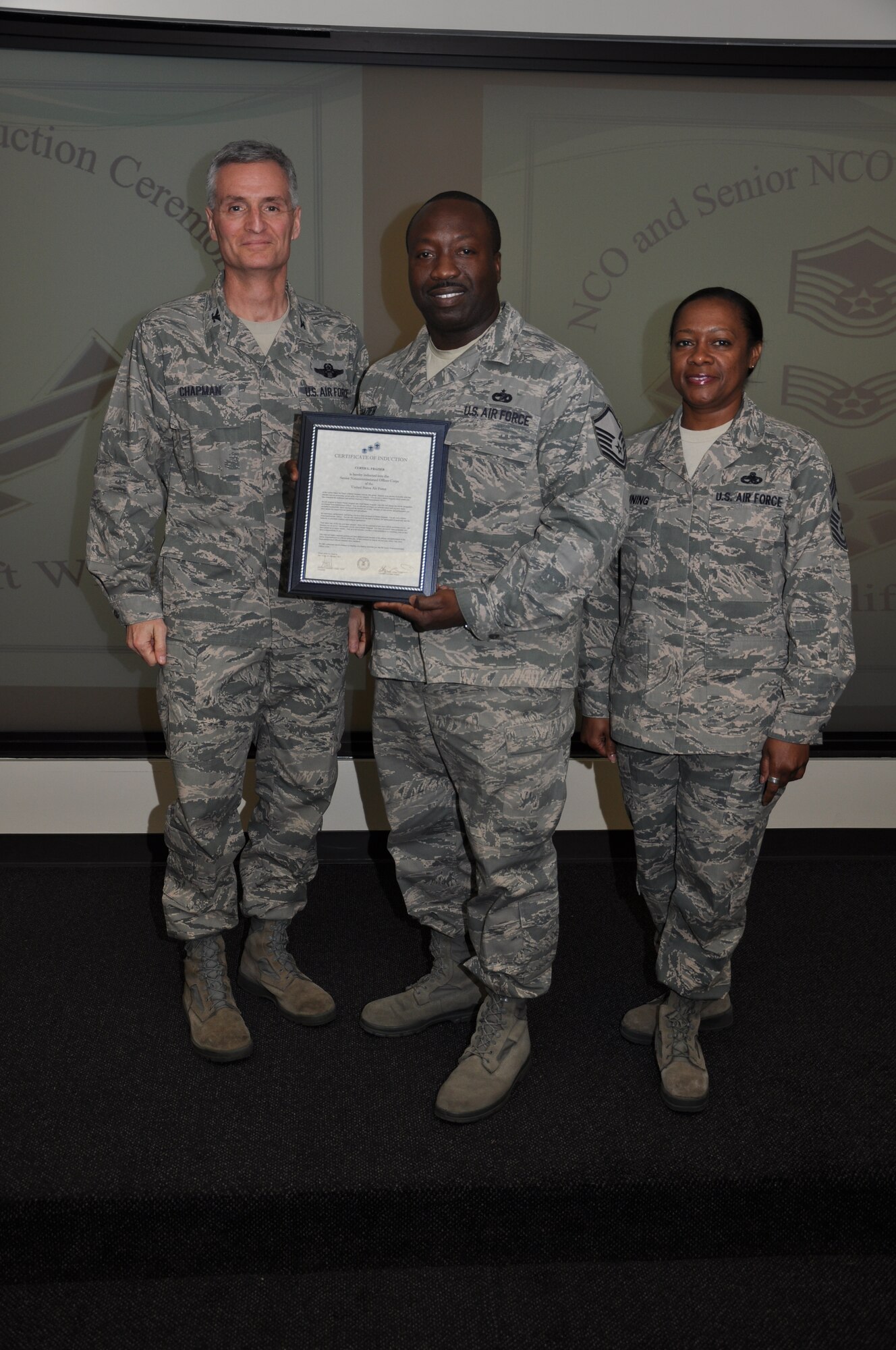 Col Steven Chapman and Command Chief Master Sergeant Gigi Manning congratulated the 315th Airlift Wing's newest NCOs and Senior NCOs during a ceremony here March 12. The induction ceremony recognized 18 airmen as they reached a personal and professional milestone.(U.S. AirForce photo/SSgt Shane Ellis)