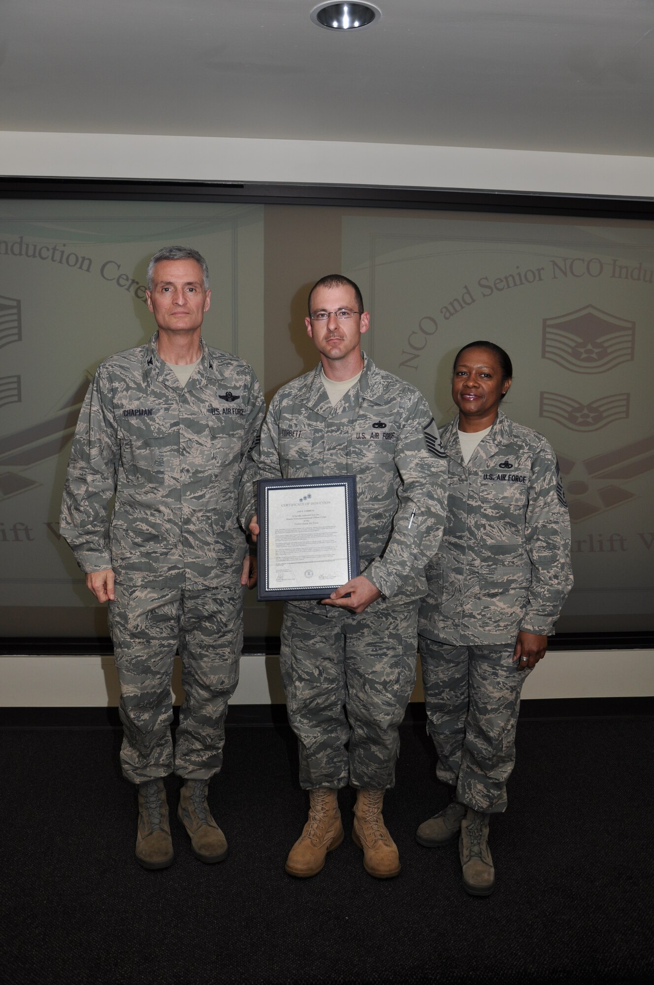 Col Steven Chapman and Command Chief Master Sergeant Gigi Manning congratulated the 315th Airlift Wing's newest NCOs and Senior NCOs during a ceremony here March 12. The induction ceremony recognized 18 airmen as they reached a personal and professional milestone.(U.S. AirForce photo/SSgt Shane Ellis)