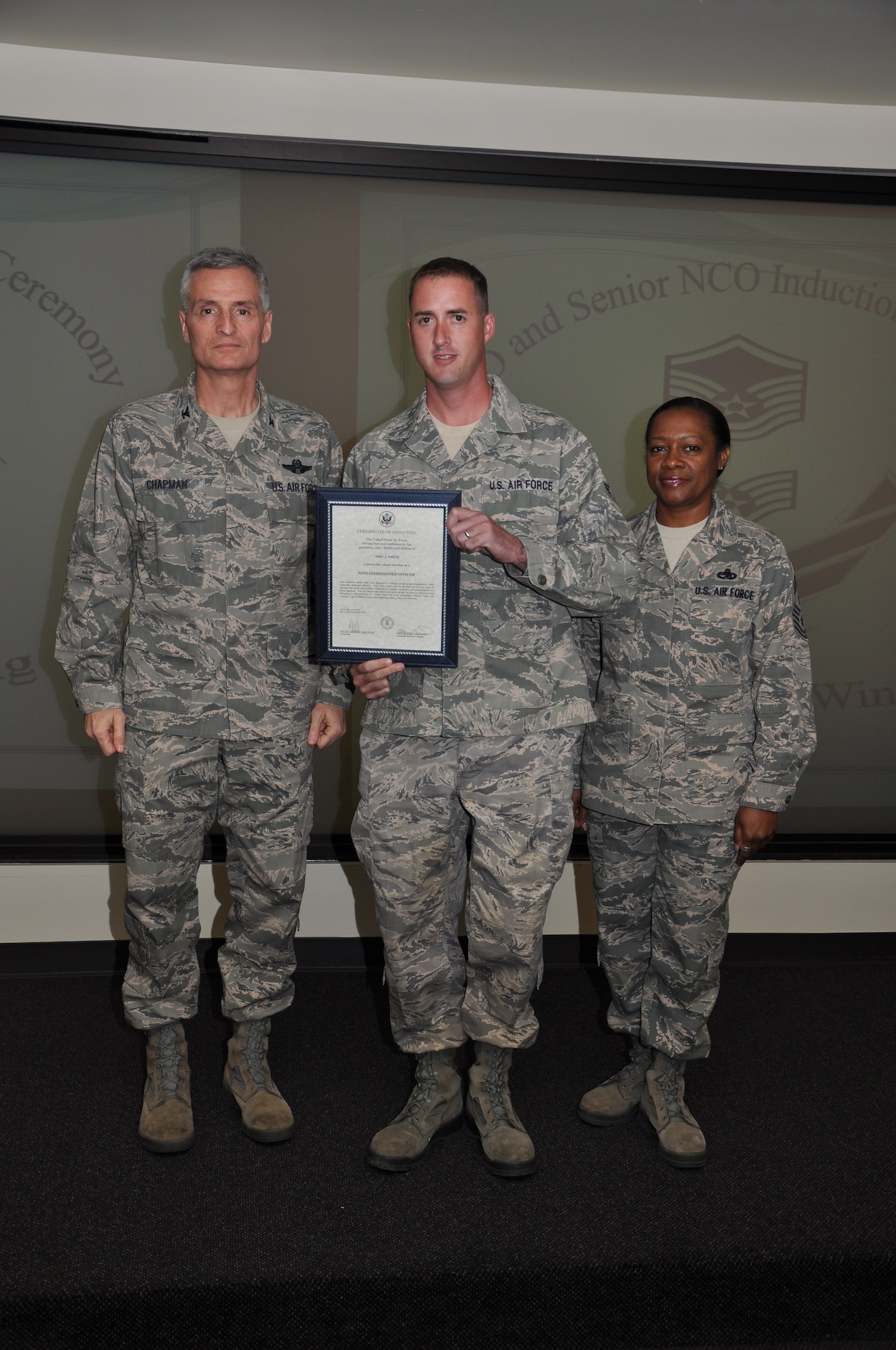 Col Steven Chapman and Command Chief Master Sergeant Gigi Manning congratulated the 315th Airlift Wing's newest NCOs and Senior NCOs during a ceremony here March 12. The induction ceremony recognized 18 airmen as they reached a personal and professional milestone.(U.S. AirForce photo/SSgt Shane Ellis)