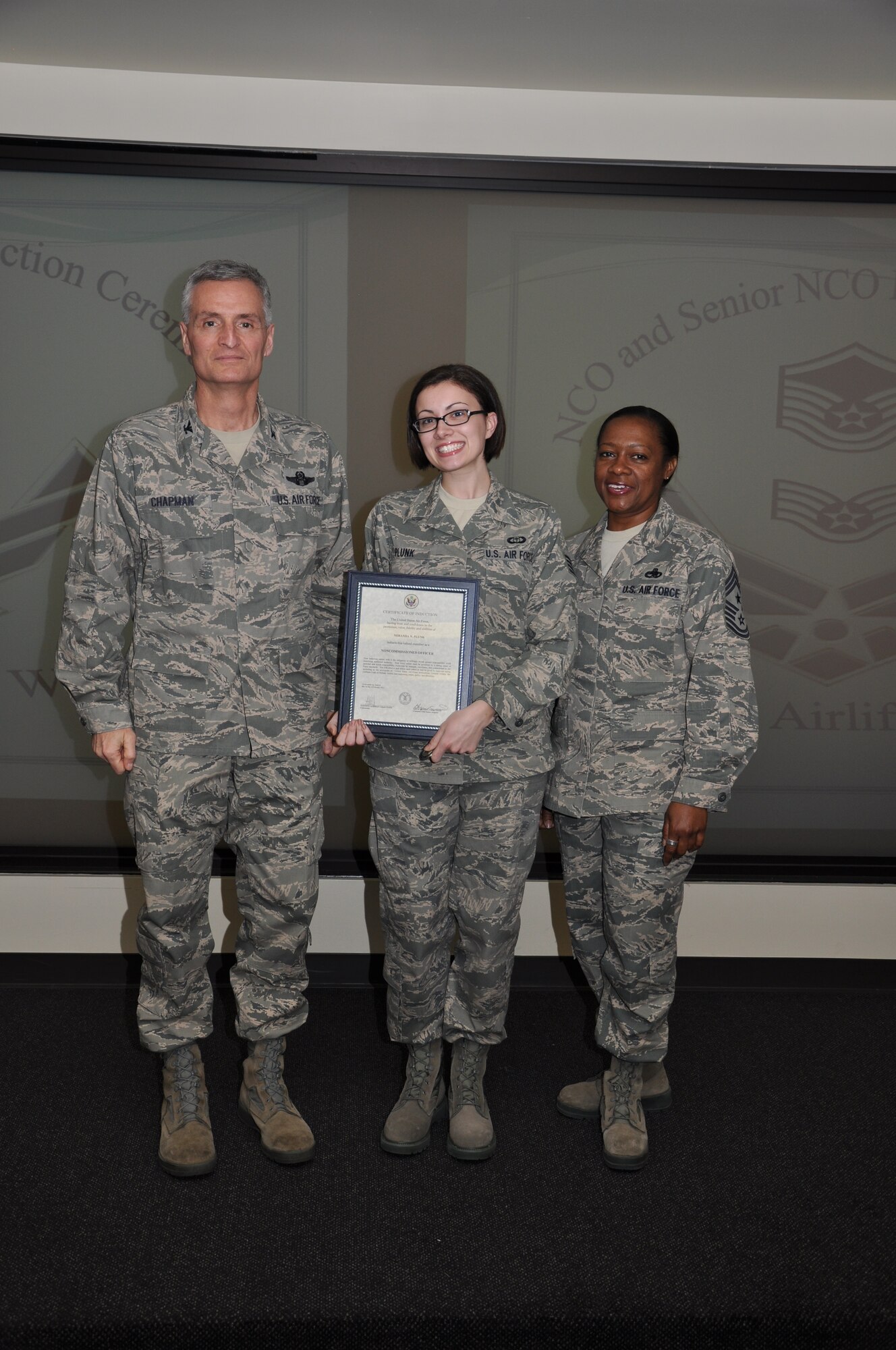 Col Steven Chapman and Command Chief Master Sergeant Gigi Manning congratulated the 315th Airlift Wing's newest NCOs and Senior NCOs during a ceremony here March 12. The induction ceremony recognized 18 airmen as they reached a personal and professional milestone.(U.S. AirForce photo/SSgt Shane Ellis)
