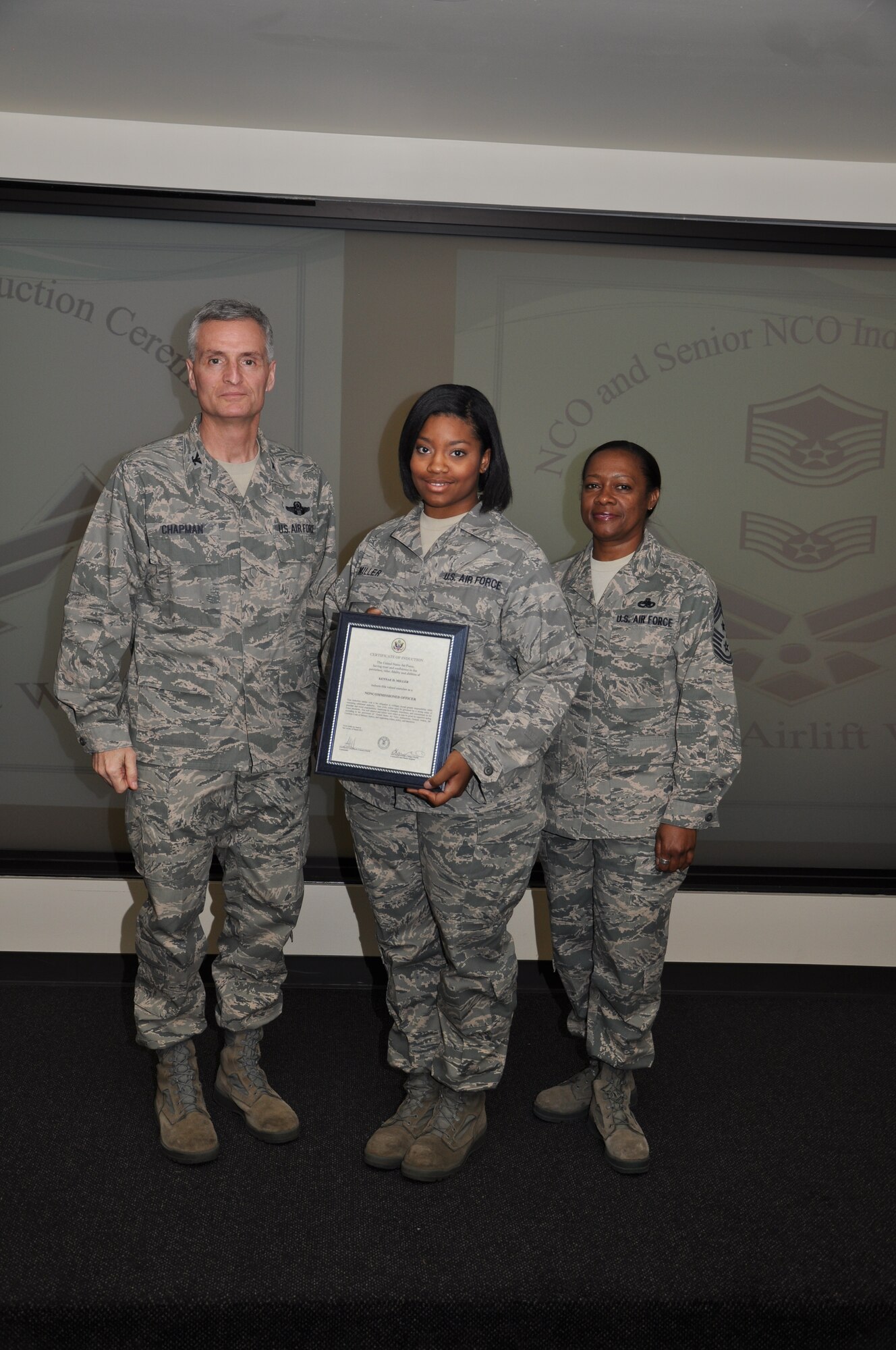 Col Steven Chapman and Command Chief Master Sergeant Gigi Manning congratulated the 315th Airlift Wing's newest NCOs and Senior NCOs during a ceremony here March 12. The induction ceremony recognized 18 airmen as they reached a personal and professional milestone.(U.S. AirForce photo/SSgt Shane Ellis)