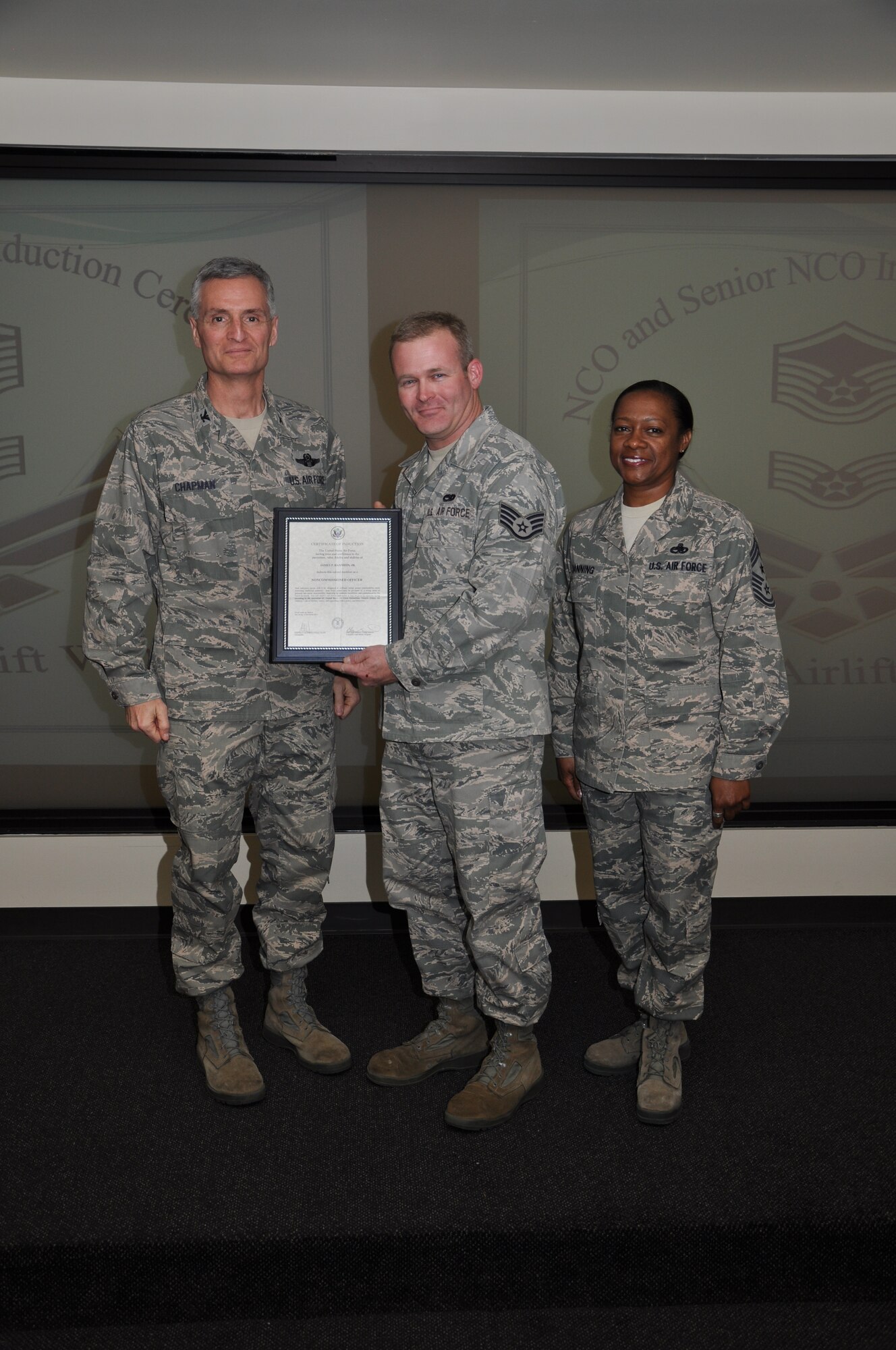 Col Steven Chapman and Command Chief Master Sergeant Gigi Manning congratulated the 315th Airlift Wing's newest NCOs and Senior NCOs during a ceremony here March 12. The induction ceremony recognized 18 airmen as they reached a personal and professional milestone.(U.S. AirForce photo/SSgt Shane Ellis)