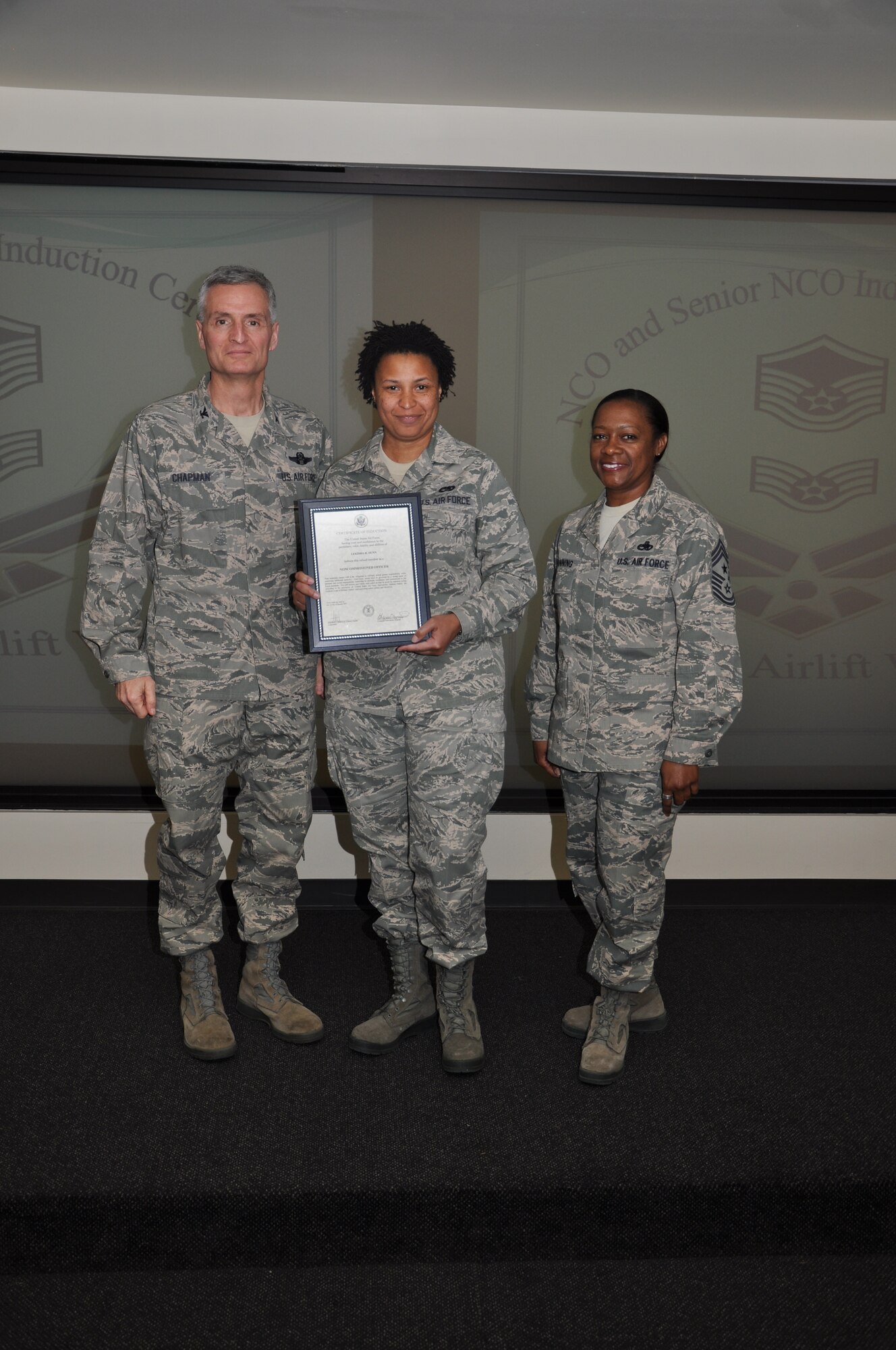 Col Steven Chapman and Command Chief Master Sergeant Gigi Manning congratulated the 315th Airlift Wing's newest NCOs and Senior NCOs during a ceremony here March 12. The induction ceremony recognized 18 airmen as they reached a personal and professional milestone.