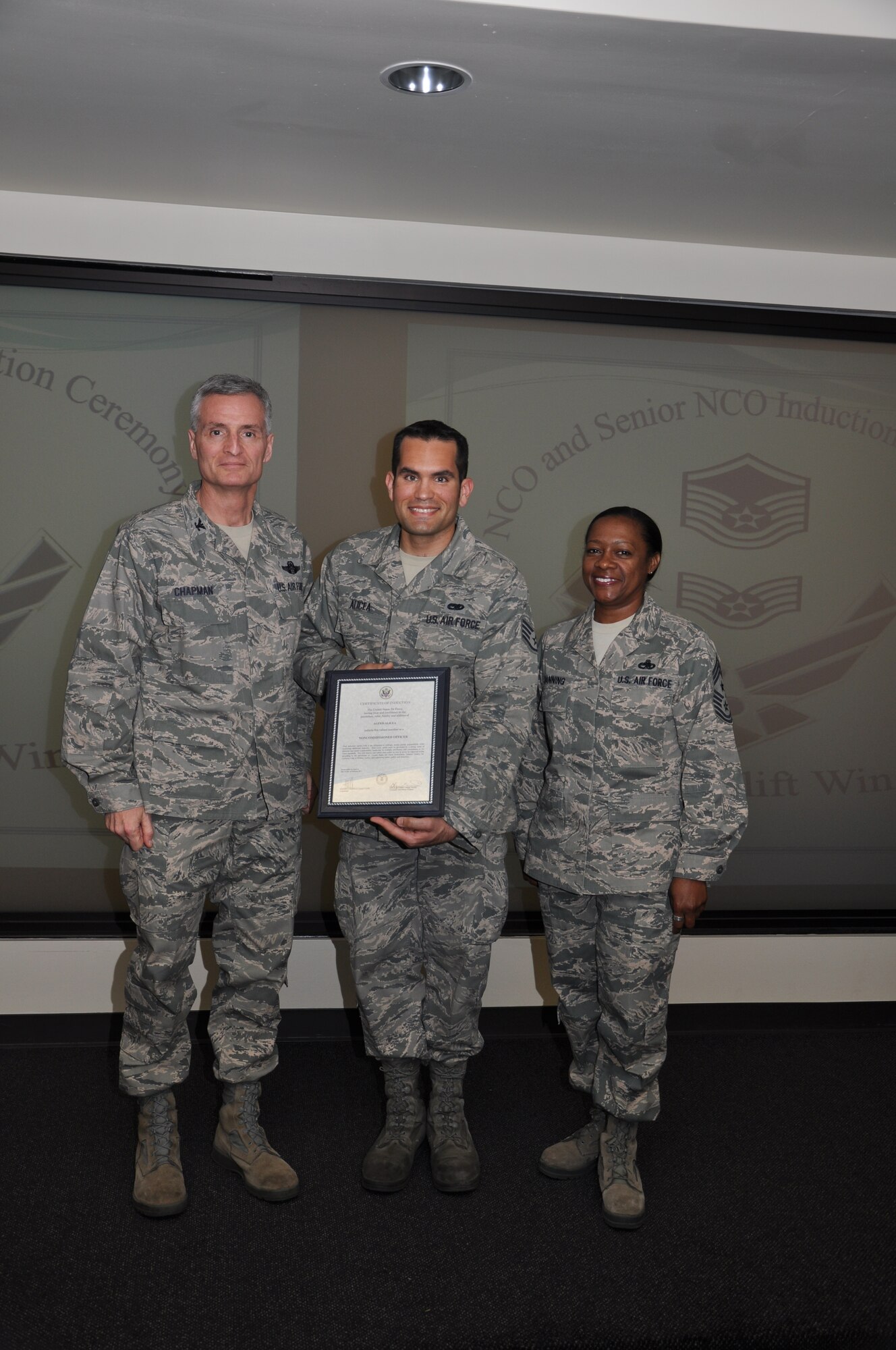Col Steven Chapman and Command Chief Master Sergeant Gigi Manning congratulated the 315th Airlift Wing's newest NCOs and Senior NCOs during a ceremony here March 12. The induction ceremony recognized 18 airmen as they reached a personal and professional milestone. (U.S. Air Force Photo/SSgt Shane Ellis)