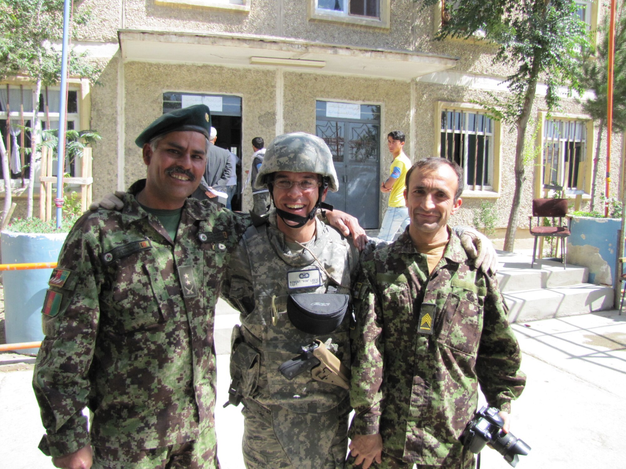 KABUL, Afghanistan - Lt. Col. Bahadur, Director of the Afghan Air Force Public Affairs, Capt. Rob Leese, NATO Air Training Command - Afghanistan, and Sgt. First Class Brother, pose for a quick photo during an AAF humanitarian mission outside of the Kabul International Airport on June 6, 2010.  (U.S. Air Force courtesy photo).
