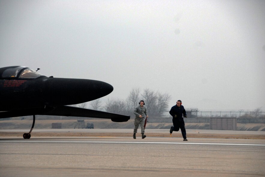 POGO crewmembers assigned to the 5th Reconnaissance Squadron prepare a U-2 aircraft for flight March 13 at Osan Air Base, Republic of Korea. The U-2 flew a humanitarian mission to capture imagery of the earthquake- and tsunami-affected areas of Japan. (U.S. Air Force photo by Senior Master Sgt. Paul Holcomb)