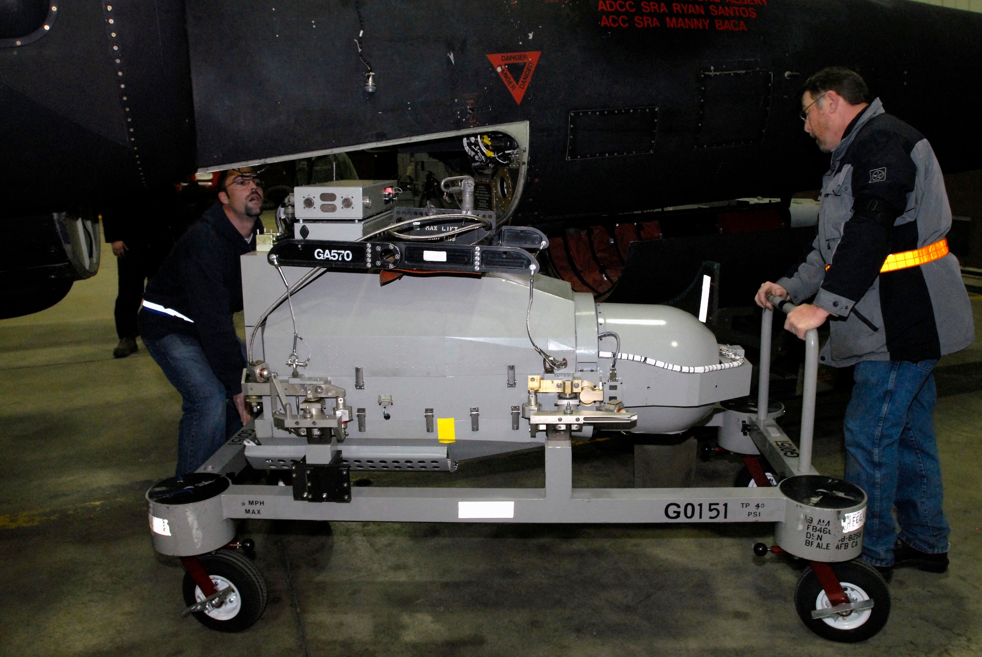 Ron Deagle, left, and Rod Blazvick, both of Goodrich ISR Division, prepare to load an Optical Bar Camera into a U-2 aircraft March 13 at Osan Air Base, Republic of Korea. The U-2 was being prepared for a humanitarian mission to capture imagery of the earthquake- and tsunami-affected areas of Japan. (U.S. Air Force photo by Senior Master Sgt. Paul Holcomb)
