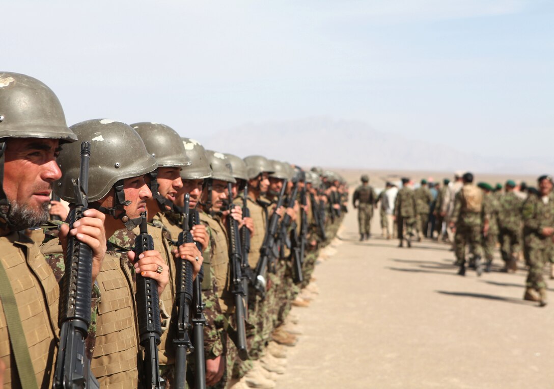 Soldiers from the 2nd Brigade, 215th Corps stand in formation for review immediately following the ribbon cutting of Delaram 1.  Delaram 1 is the Afghan National Army's newest base.  The ceremony included elders from the District of Delaram, local government officials and representatives from the Army Corps of Engineers that built the base, March 14.  (Official Marine Corps Photo By 1st Lt. Irish)