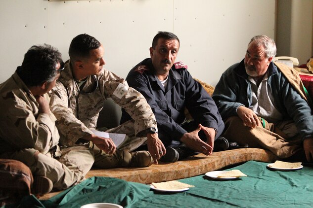 Marines, with 3rd Battalion, 1st Marine Regiment, and role players of the local army and police force talk with village elders about their problems and concerns during the final week of an Advisor Training Group course March 14, 2011.