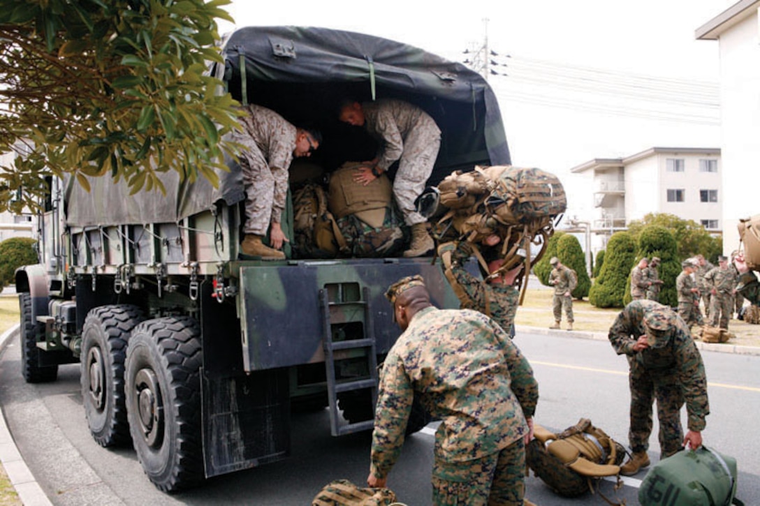 Marines attached to Humanitarian Assistance Survey Teams, III Marine Expeditionary Force (Forward), prepare to travel to Sendai as part of the disaster relief effort in Japan March 14.