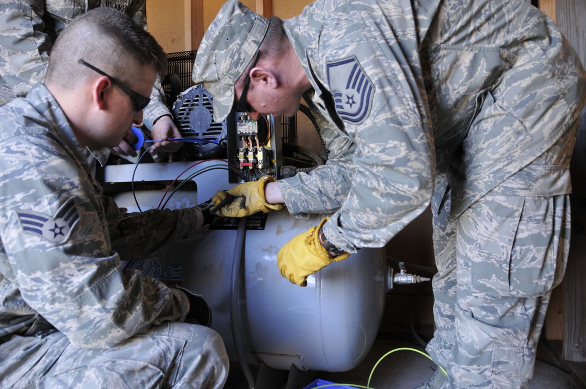 SAN CLEMENTE ISLAND, Calif. -- Master Sgt. Tom Bradley, supervisor of the 176th Civil Engineer Squadron's Electrical Section, shows a junior member of his section how to hook up a compressor to electrical power here March 12. 

Bradley is a resident of Wasilla, Alaska. He deployed to this remote location off the coast of southern California to train with his Air National Guard unit. The 176 CES, part of the Alaska Air National Guard's 176th Wing, deployed to San Clemente Island for two weeks in March 2011 to train and work on a variety of infrastructure projects. 

Alaska Air National Guard photo by Staff Sgt. N. Alicia Goldberger.