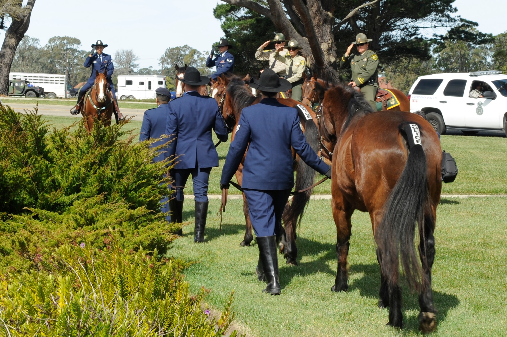 Leading a last salute for Military Working Horses Judge and Willy,  Lt. Col. Michelle Stringer, the 30th Security Forces Squadron commander, ushers the horses into retirement at a ceremony at Missile V here Monday, March 14, 2011. (U.S. Air Force photo/Senior Airman Lael Huss)