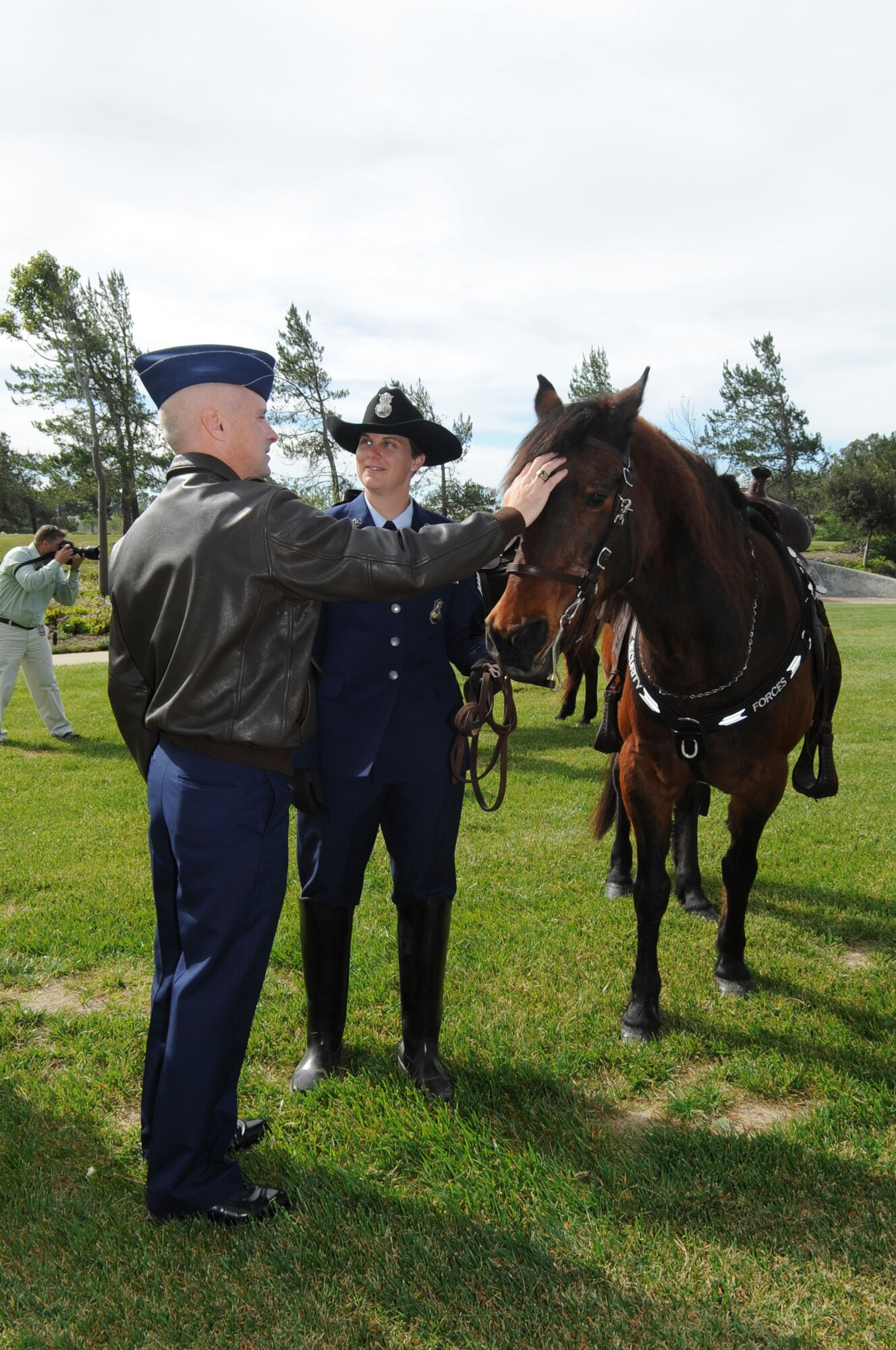 Col. Richard Boltz, the 30th Space Wing commander, meets military working horse Willy and his handler Staff Sgt. Andrea Lewis, of the 30th Security Forces Squadron, during his retirement ceremony at Missile V here Monday, March 14, 2011. Military working horses Willy and Judge retire after a combined 35 years in military service. (U.S. Air Force photo/Senior Airman Lael Huss)