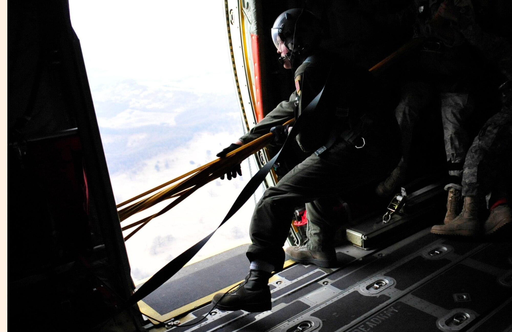 U.S. Air Force Staff Sgt. Jim Gettis, 37th Airlift Squadron loadmaster, pulls static lines into a C-130J after a successful static line jump of Romanian paratroopers that exited the aircraft over a landing zone near Campia Turzii, Romania, March 14, 2011. The jump was performed on the first day of Carpathian Spring 2011, a building partnerships capacity exercise where members of the U.S. military join their Romanian counterparts to learn from one another and strengthen alliances. (U.S. Air Force Photo by Tech Sgt. Jocelyn L. Rich)