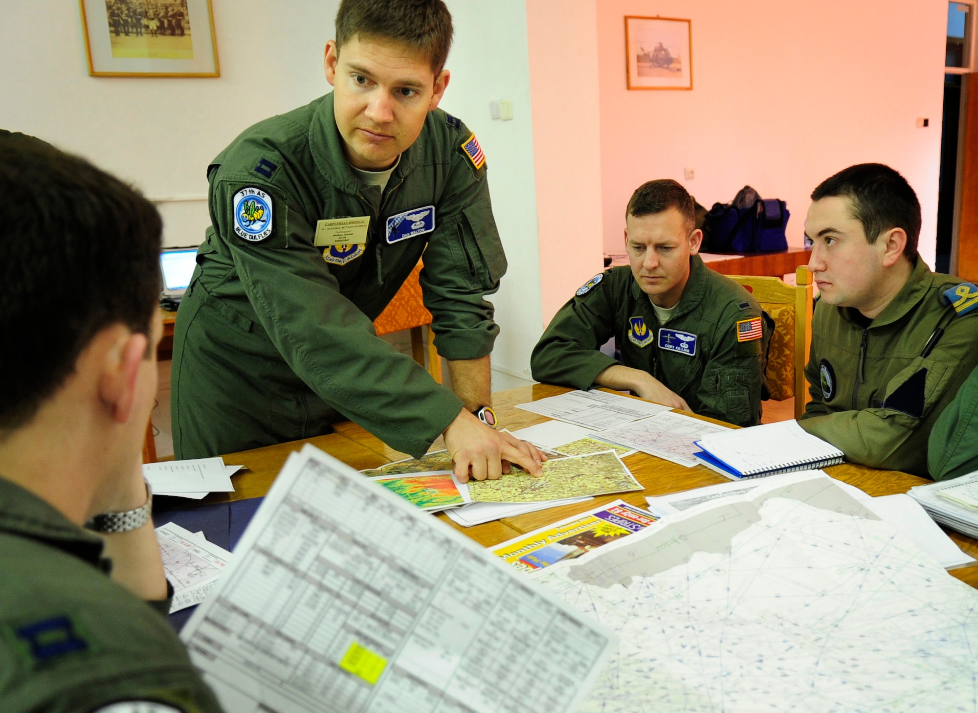 U.S. Air Force Capt. Dan Walton, 37th Airlift Squadron pilot, delivers information to crews of U.S. Air Force C-130Js and their Romanian counterparts, during a pre-flight briefing, Airlift Base Otopeni, Romania, March 14, 2011. Captain Walton is serving as the mission commander of Carpathian Spring 2011, a building partnership capacity exercise where members of the U.S. military join their Romanian counterparts to learn from one another and strengthen alliances. (U.S. Air Force Photo by Tech Sgt. Jocelyn L. Rich)