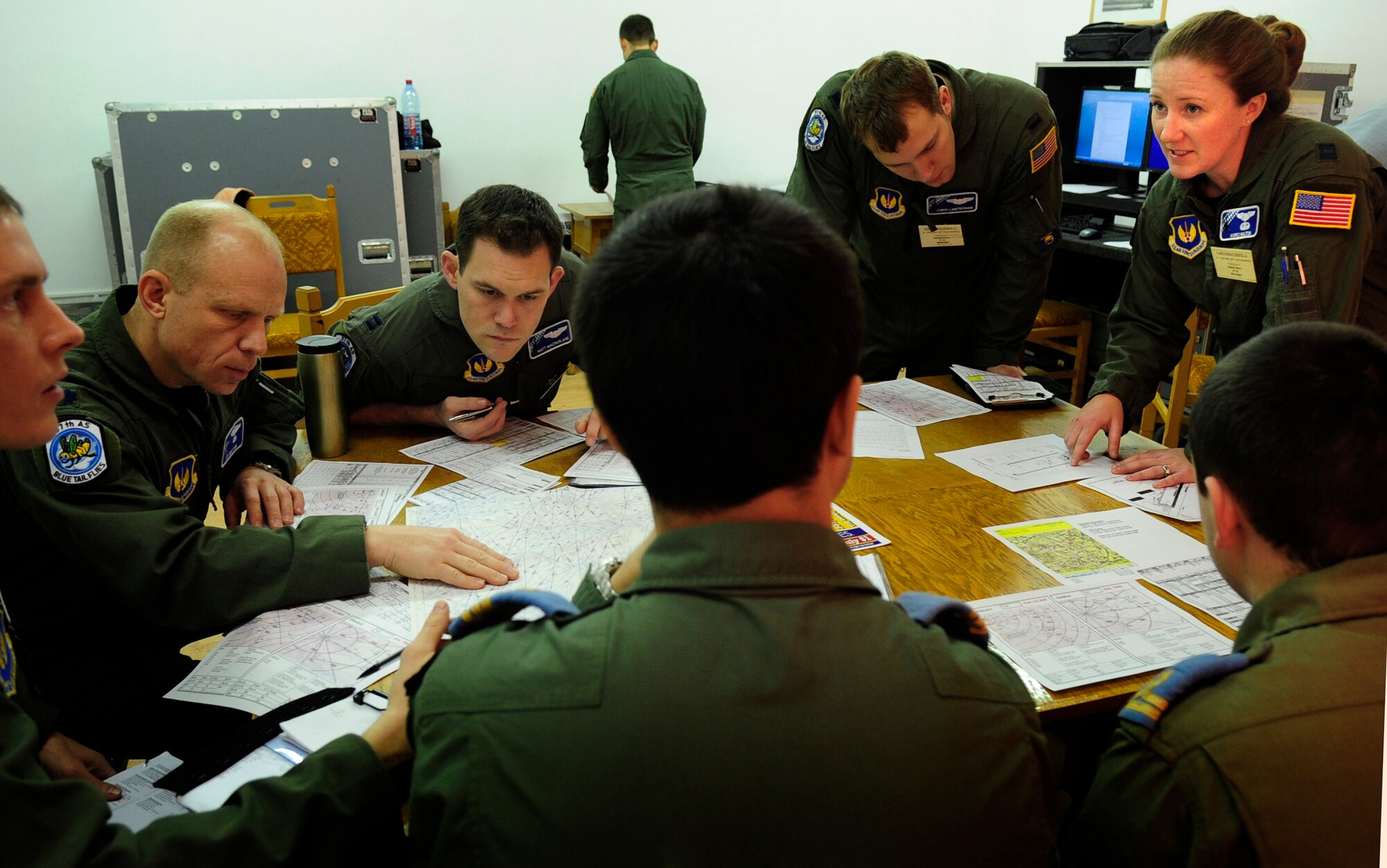 U.S. Air Force Capt. Marcie Walton, 37th Airlift Squadron, delivers information to crews of U.S. Air Force C-130Js and their Romanian counterparts, during a pre-flight briefing, Airlift Base Otopeni, Romania, March 14, 2011. Capt. Walton is serving as the chief of tactics during Carpathian Spring 2011, a building partnership capacity exercise where members of the U.S. military join their Romanian counterparts to learn from one another and strengthen alliances. (U.S. Air Force Photo by Tech Sgt. Jocelyn L. Rich)