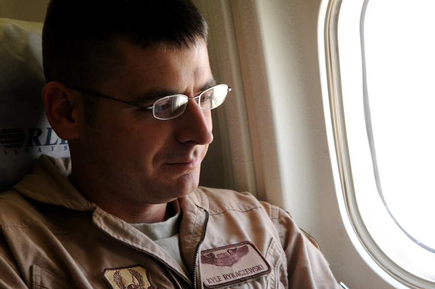 MOODY AIR FORCE BASE, Ga.-- Capt. Kyle Rykaczewski, 74th Fighter Squadron A-10C Thunderbolt II pilot, reads a book as he flies with nearly 300 members of the 23rd Maintenance Group to a six month deployment in Afghanistan March 14. Many members listened to music, played movies and found other ways to pass the time during the long flight. (U.S. Air Force photo/Airman 1st Class Benjamin Wiseman)(RELEASED)