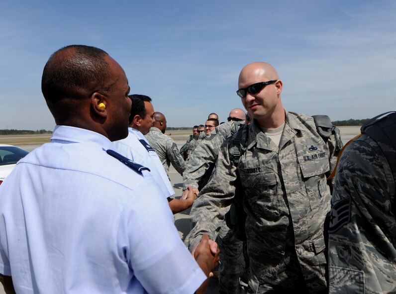 MOODY AIR FORCE BASE, Ga.-- Col. Neal Robinson, 23rd Maintenance Group commander, shakes hands with Master Sgt. Jeremy Stauty, 23rd Aircraft Maintenance Squadron, as members of the 23rd MXG load a commercial aircraft March 14. These members of the 23rd MXG will be replacing other members from team Moody that have been deployed to Afghanistan since Sept. 2010. (U.S. Air Force photo/Airman 1st Class Benjamin Wiseman)(RELEASED)