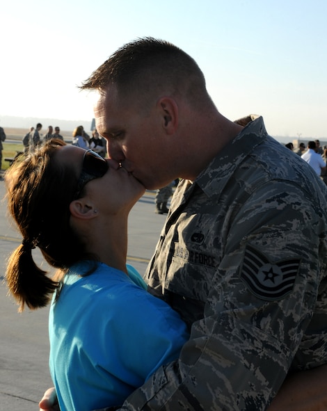 MOODY AIR FORCE BASE, Ga.-- Tech. Sgt. James Jessup, 23rd Aircraft Maintenance Unit flightline expediter, kisses his girlfriend, Tiffany Buchanan before leaving on a six month deployment to Afghanistan March 14. Sergeant Jessup will be traveling by commercial aircraft with nearly 300 other members of the 23rd Maintenance Group for their deployment. (U.S. Air Force photo/Airman 1st Class Benjamin Wiseman)(RELEASED)