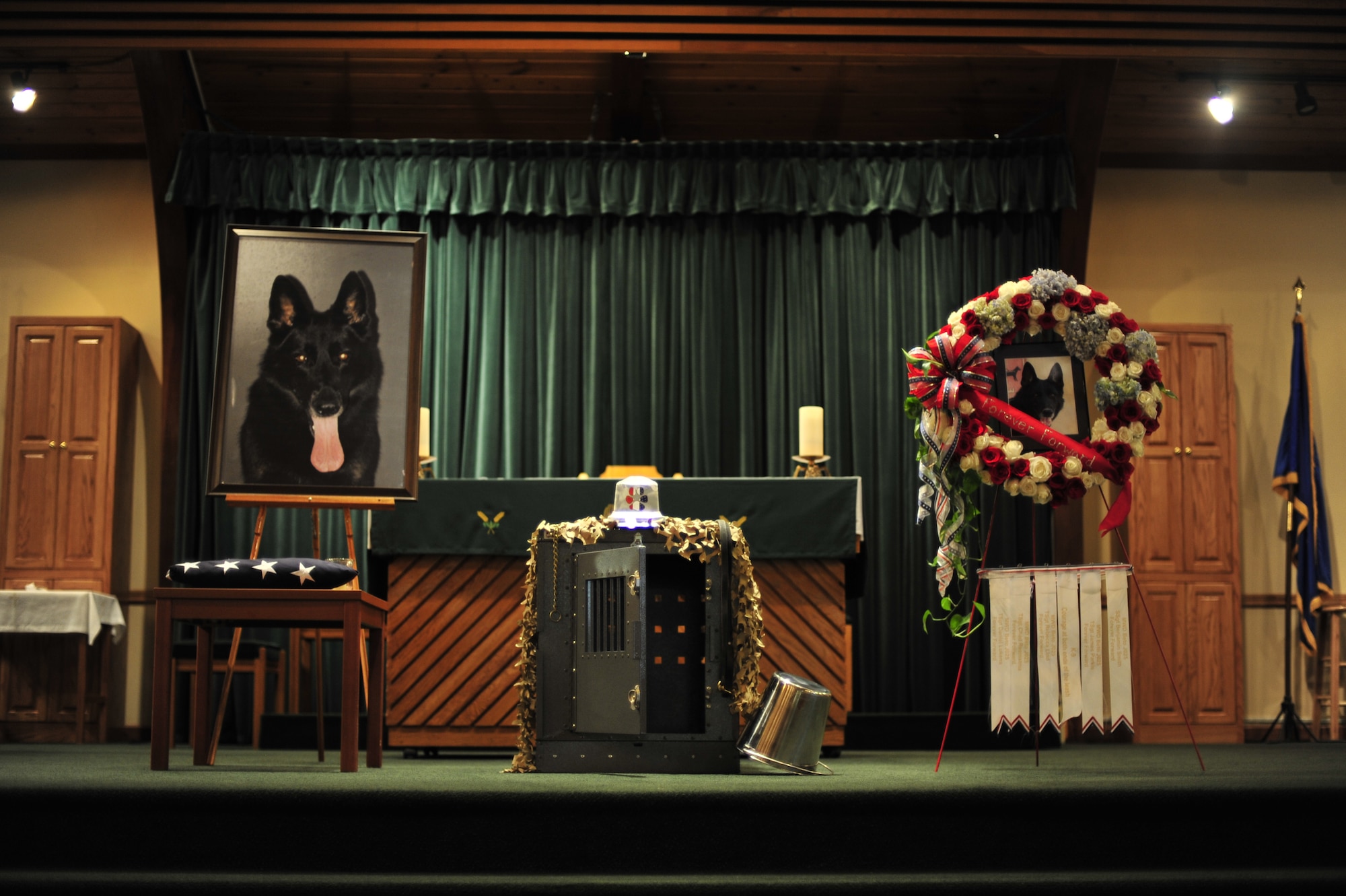 A military working dog kennel is on display during a memorial service at the base chapel at Hurlburt Field, Fla., March 8, 2011. MWD Beto, a narcotics detection dog assigned to the 1st Special Operations Security Forces Squadron, died of natural causes while serving in Operation Enduring Freedom. (U.S. Air Force photo by Staff Sgt. Stephanie Jacobs / RELEASED)