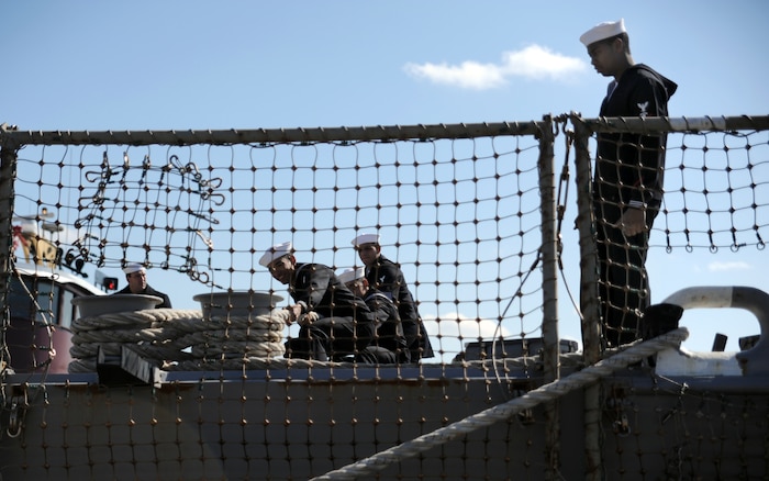 Sailors pull the ship closer to the dock and secure the line after making port at the marina March 11, 2011 at the Charleston, S.C. The USS Farragut was named in honor of the U.S. Navy's first admiral, David Glasgow Farragut. It is the fifth ship to bear this name. (U.S. Air Force photo/Senior Airman Timothy Taylor)
