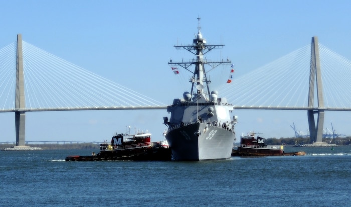 Tug boats position the USS Farragut in Charleston Harbor as she prepares to moor in Downtown Charleston March 11, 2011 in Charleston, S.C. Farragut is an Arleigh Burke-class guided missile destroyer with the primary role to conduct promptly, sustain combat operations at sea in support of national policy. (U.S. Air Force photo/Senior Airman Timothy Taylor)  
