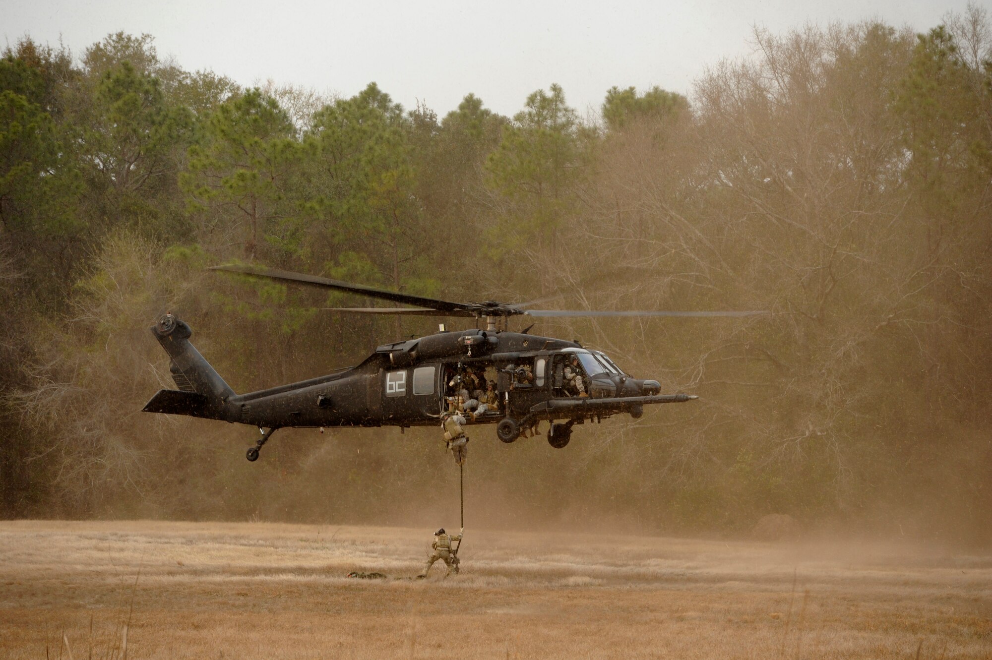 A U.S. Soldier assigned to the 4th Battalion, 10th Special Forces Group fast ropes out of a UH-60 Black Hawk helicopter near Tallahassee Regional Airport, Fla., before Emerald Warrior 2011 March 2, 2011. Emerald Warrior is an annual two-week joint/combined tactical exercise sponsored by U.S. Special Operations Command to provide realistic training opportunities to conventional and special operations forces. (U.S. Air Force photo by Senior Airman Staci Miller/Released)