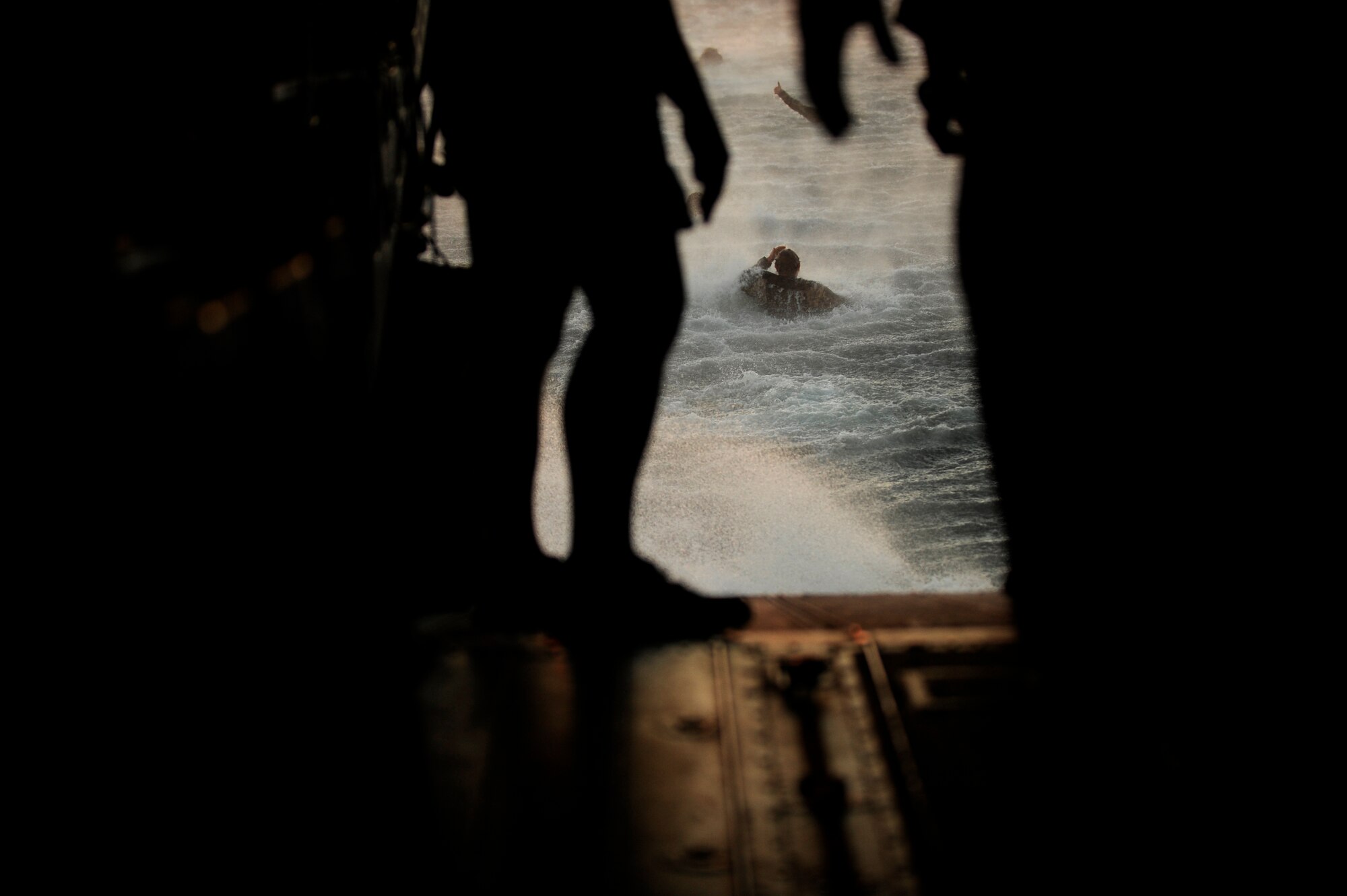 U.S. Army Soldiers assigned to the 10th Special Forces Group, swim away form  CH-47 Chinook helicopter assigned to the 160th Special Operations Aviation Regiment after jumping out of it during water training, March 1, 2011 over the Gulf of Mexico  in support of Emerald Warrior 2011. Emerald Warrior 2011 is a U.S. Special Operations Command-sponsored, multiservice exercise designed to leverage lessons learned from Operations Iraqi Freedom and Enduring Freedom to provide trained and ready forces to combatant commanders. (U.S. Air Force photo/ Tech Sgt. Manuel J. Martinez)(Released)