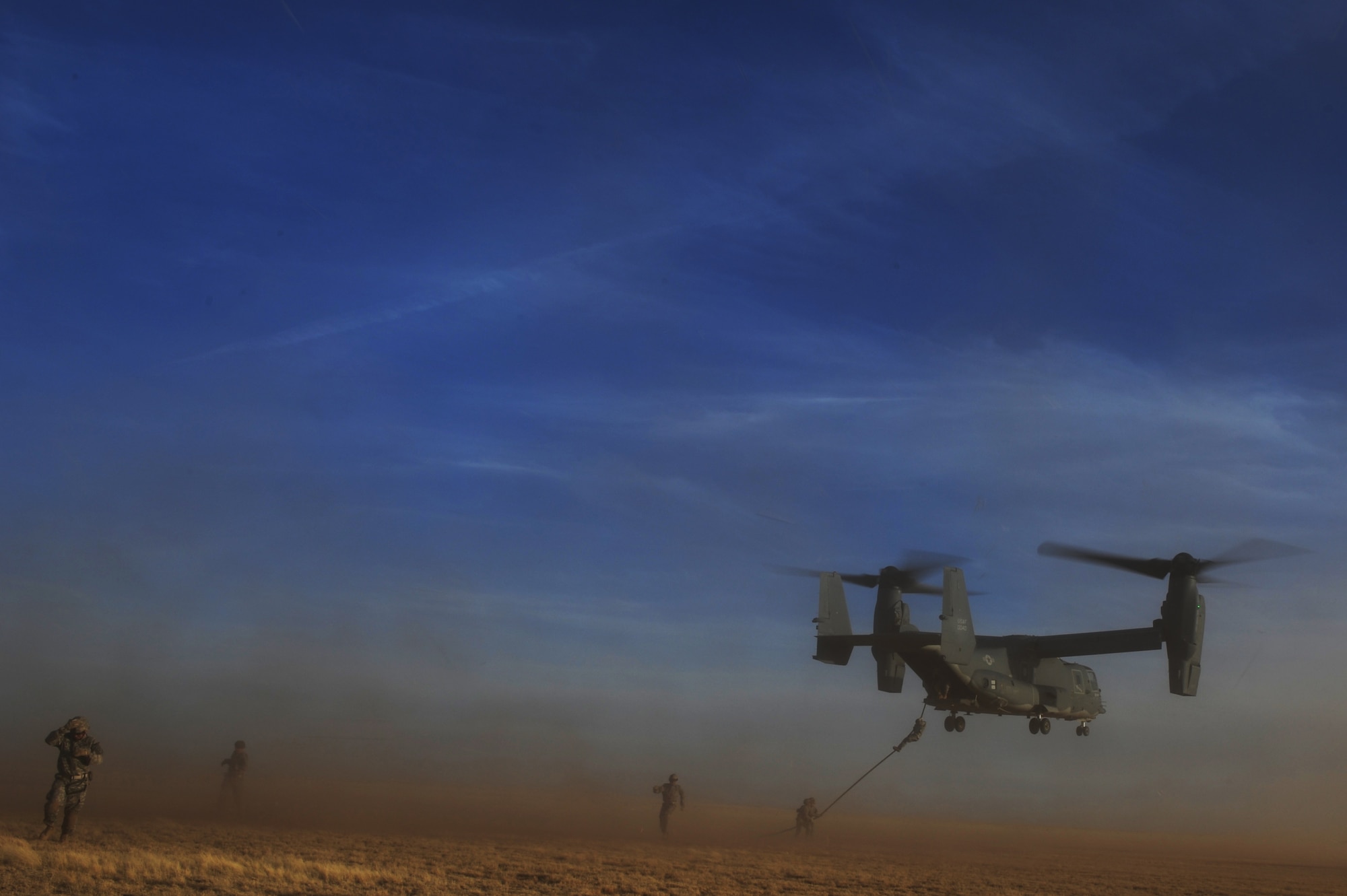 U.S. Soldiers assigned to Alpha Company, 4th Battalion, 10th Special Forces Group exit via rope an Air Force CV-22 Osprey during Emerald Warrior 2011 March 1, 2011, at Cannon Air Force Base, N.M. Emerald Warrior is an annual two-week joint/combined tactical exercise sponsored by U.S. Special Operations Command to provide realistic training opportunities to conventional and special operations forces. (U.S. Air Force photo by Tech. Sgt. DeNoris Mickle/Released)