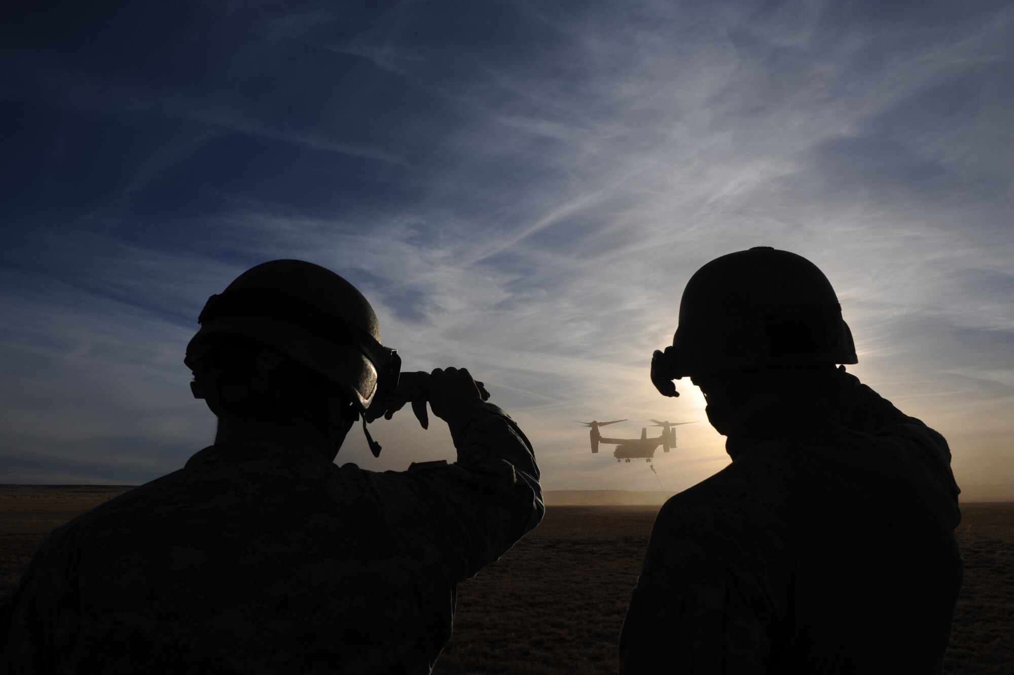 U.S. Soldiers assigned to Alpha Company, 4th Battalion, 10th Special Forces Group watch an Air Force CV-22 Osprey tiltrotor aircraft during Emerald Warrior 2011 March 1, 2011, at Cannon Air Force Base, N.M. Emerald Warrior is an annual two-week joint/combined tactical exercise sponsored by U.S. Special Operations Command to provide realistic training opportunities to conventional and special operations forces. (U.S. Air Force photo by Tech. Sgt. DeNoris Mickle/Released)