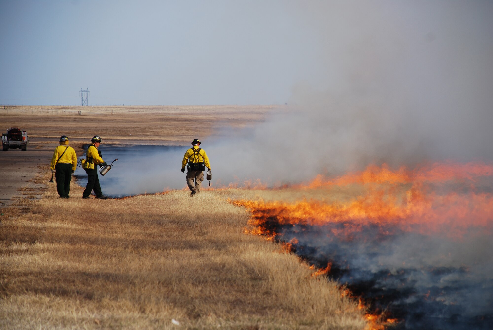 Firefighters from Burkburnett, Texas, monitor a controlled burn March 12 at Sheppard Air Force Base. The burn was a test to see how vegetation responds to the burn as well as the effects it has on wildlife along the base's flightline. (U.S. Air Force photo/John Ingle)