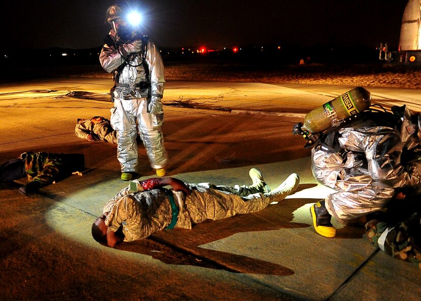 51st Fighter Wing Firefighters aid simulated casualties during Operational Readiness Exercise Beverly Midnight 11-02 at Osan Air Base, Republic of Korea March. 14. The exercise allows Airmen to demonstrate their ability to complete the mission in simulated chemical environments while executing their primary duties, practicing self aid and buddy care, conduction post-attack reconnaissance and unexploded ordnance sweeps. (U.S. Air Force Photo/Senior Airman Evelyn Chavez)