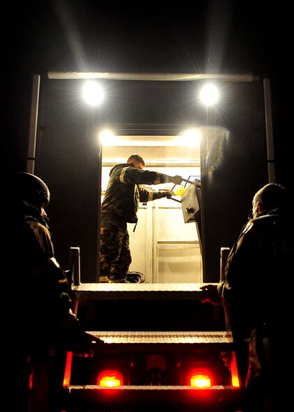 51st Fighter Wing Exercise Evaluation Team members prepare a setup for a simulated scenario during Operational Readiness Exercise Beverly Midnight 11-02 at Osan Air Base, Republic of Korea March 14. The exercise allows Airmen to demonstrate their ability to complete the mission in simulated chemical environments while executing their primary duties, practicing self aid and buddy care, conduction post-attack reconnaissance and unexploded ordnance sweeps. (U.S. Air Force Photo/Senior Airman Evelyn Chavez)