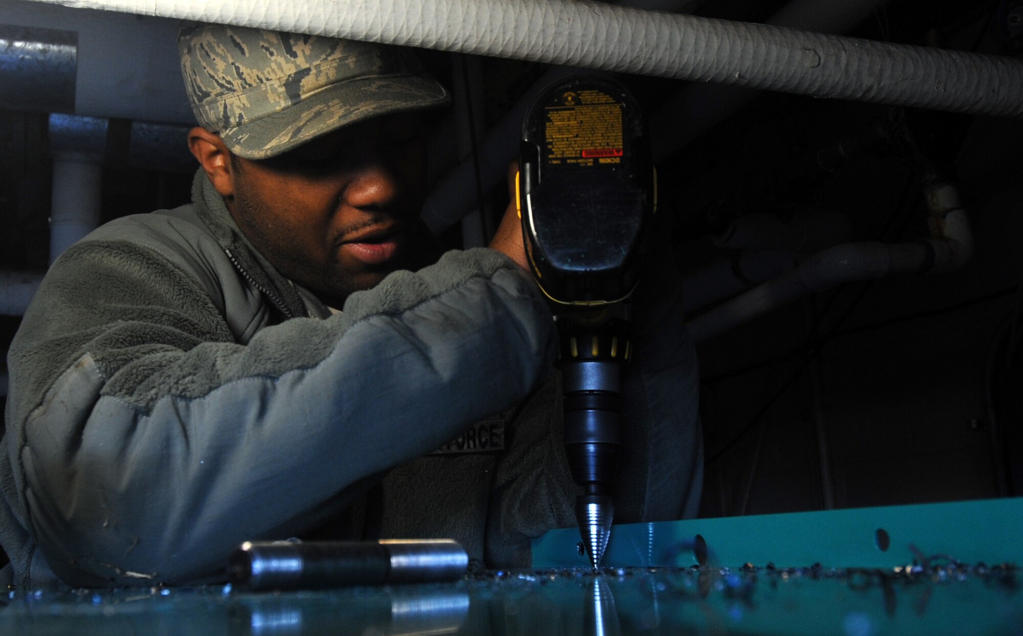 MOODY AIR FORCE BASE, Ga. -- Senior Airman Desmonn Comeaux, 23rd Civil Engineer Squadron electrical power production journeyman, drills holes into a new automatic transfer switch March 12. These holes will provide an easy way to insert electric cables into the automatic transfer switch. (U.S. Air Force photo/Airman 1st Class Douglas Ellis)(RELEASED)
