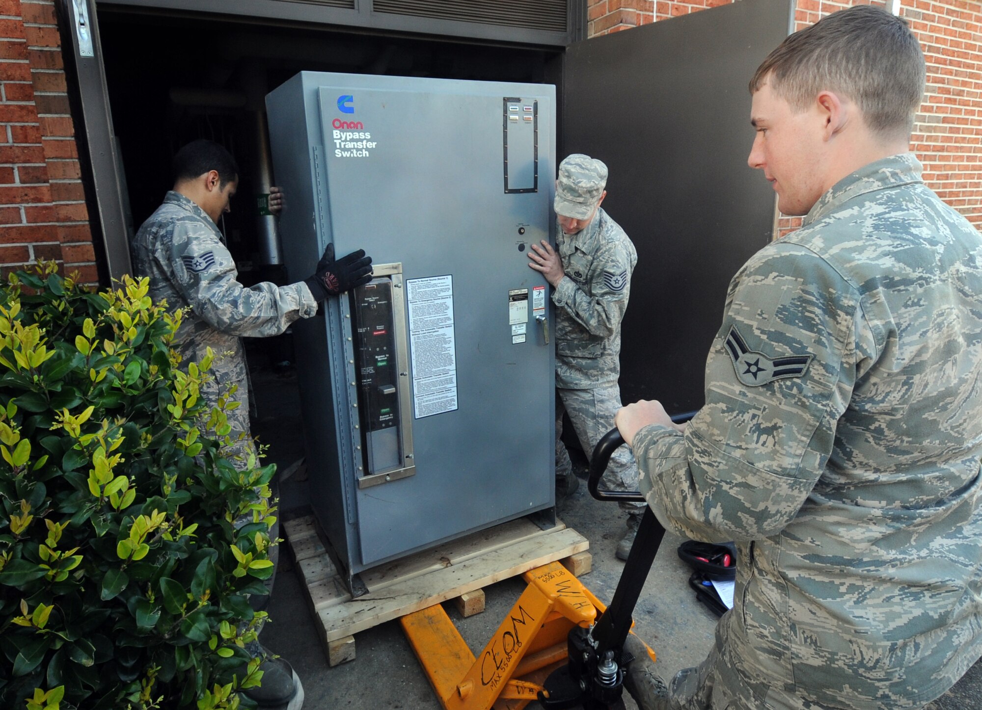 MOODY AIR FORCE BASE, Ga. -- Members from the 23rd Civil Engineer Squadron move an automatic transfer switch onto a pallet March. 12. The switch was replaced with a new one because it could no longer transfer power to a generator. (U.S. Air Force photo/Airman 1st Class Douglas Ellis)(RELEASED)
