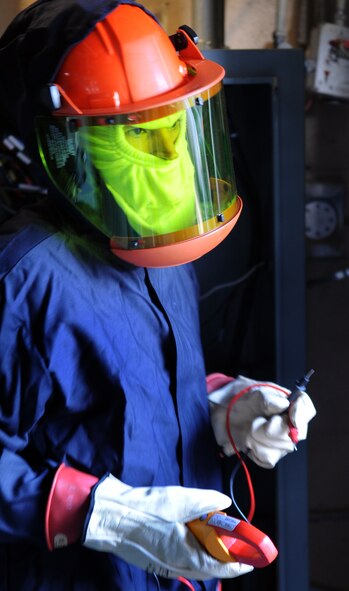 MOODY AIR FORCE BASE, Ga. -- Staff Sgt. Emanuel Flores, 23rd Civil Engineer Squadron electrical power production journeyman, holds a fluke after checking to see if the old automatic transfer switch has power March 12. The fluke is used as a safe way to find out if an electrical wire has power. (U.S. Air Force photo/Airman 1st Class Douglas Ellis)(RELEASED)
