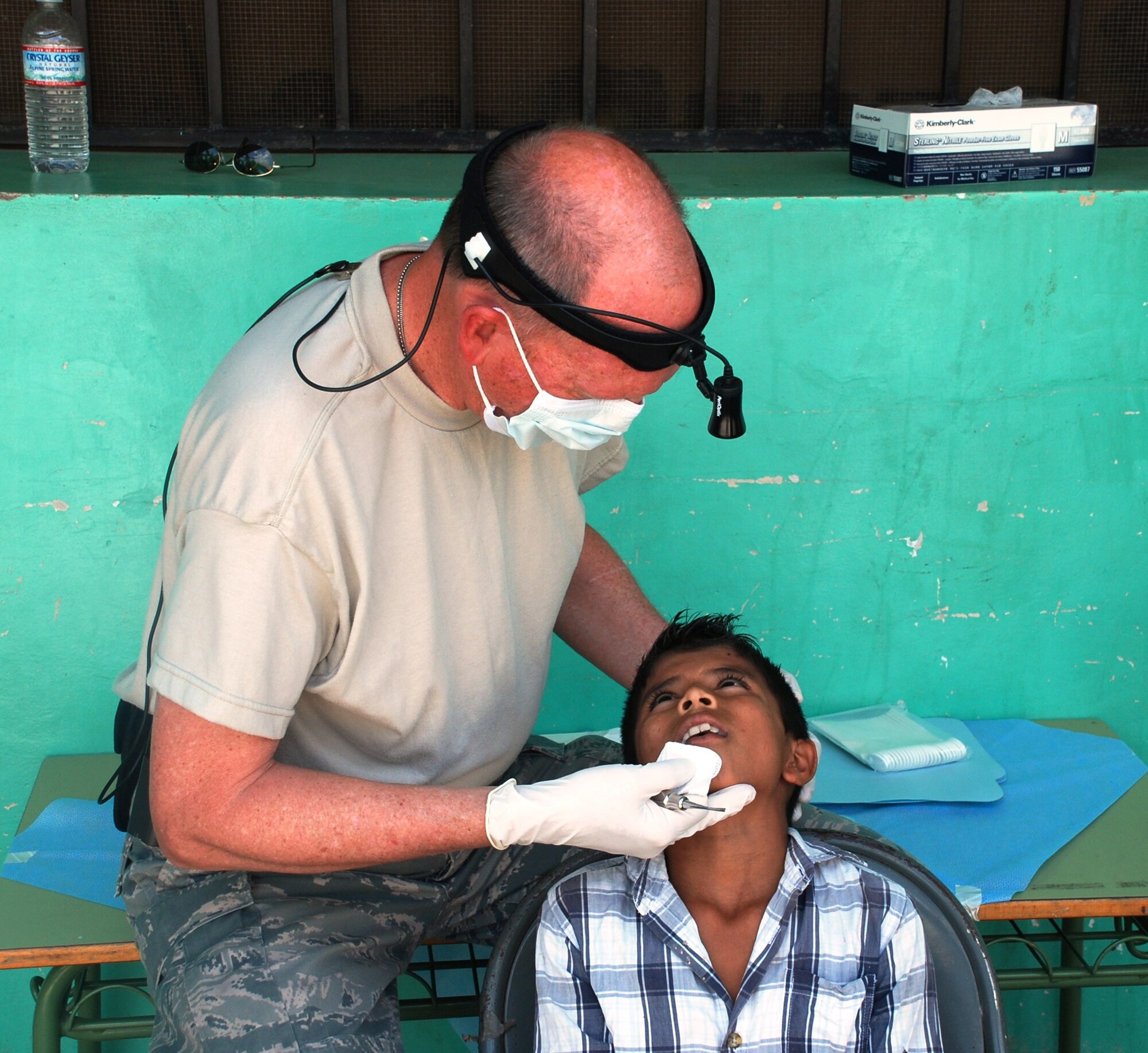 SOTO CANO AIR BASE, Honduras - Lt. Col. Thompson Lanius, Joint Task Force-Bravo Medical Element Dental Services officer, performs a routine dental check on a patient in Choluteca Mar. 11.  Colonel Lanius was part of a Medical Readiness and Training Exercise held there to assist the Honduran Ministry of Health in providing basic medical services to residents of the area.  JTF-Bravo routinely conducts training exercises throughout Central Americal to ensure regional stability as well as to our ability to respond to natural disasters, provide humanitarian assistance, and protect the vital interests of the United States. (U.S. Air Force photo/Capt. John T. Stamm)